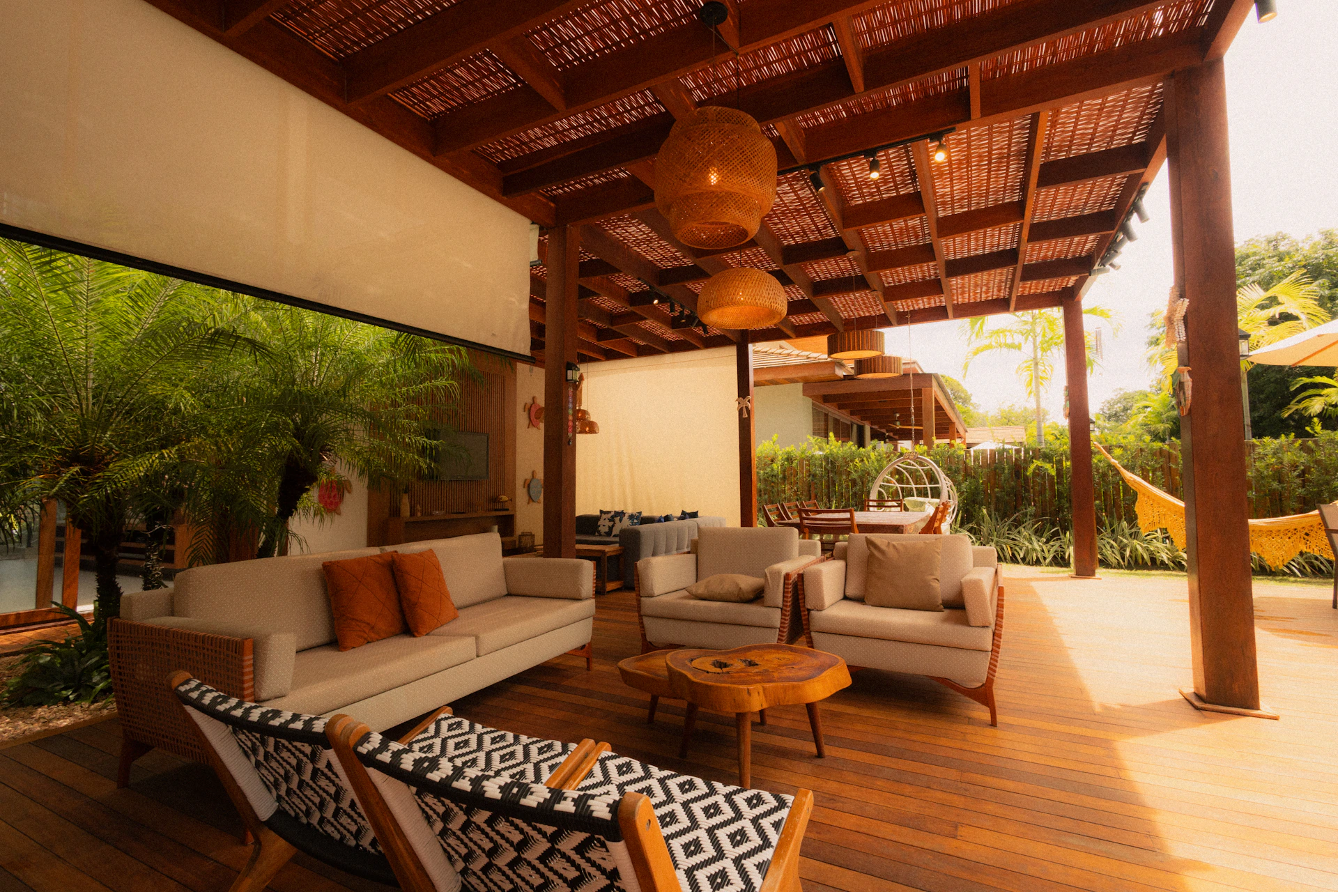 Outdoor living space with sofas and hanging chairs