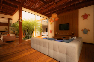 Modern living room with large couch and indoor plants