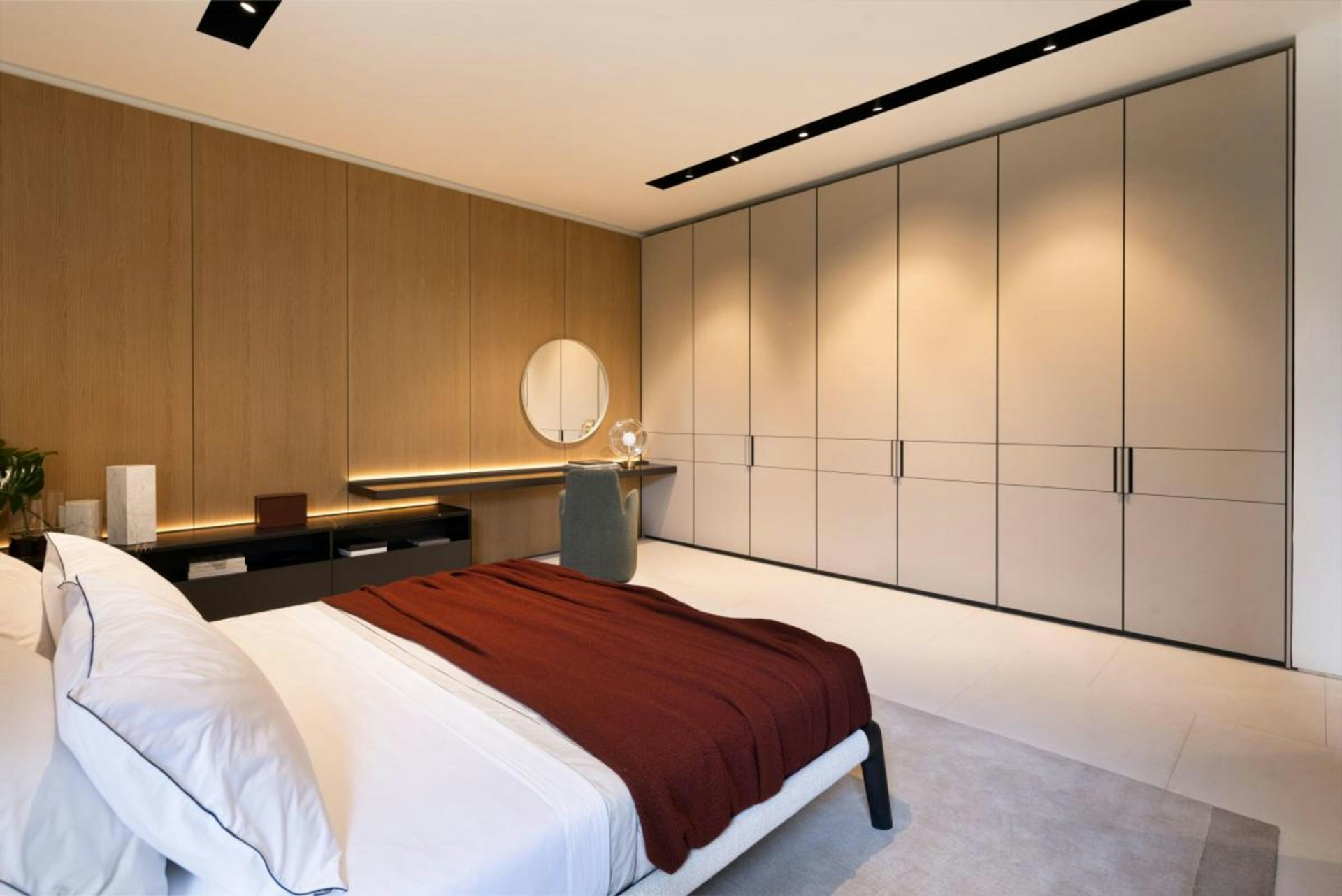 Modern bedroom with large wardrobe and vanity area fortable bed.