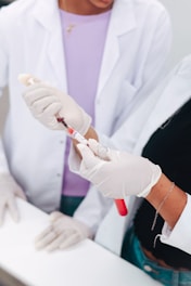 Two scientists examining a blood sample in a test tube.