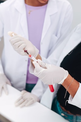 Two scientists examining a blood sample in a test tube.