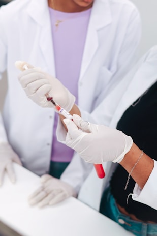Two scientists examining a blood sample in a test tube.