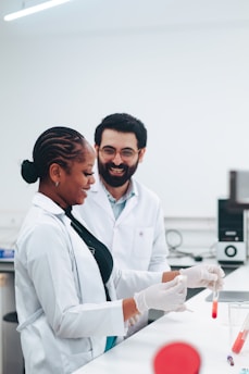 Two scientists working with test tubes in a lab.