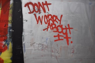 Red graffiti reads dont worry about it