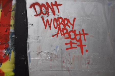 Red graffiti reads dont worry about it
