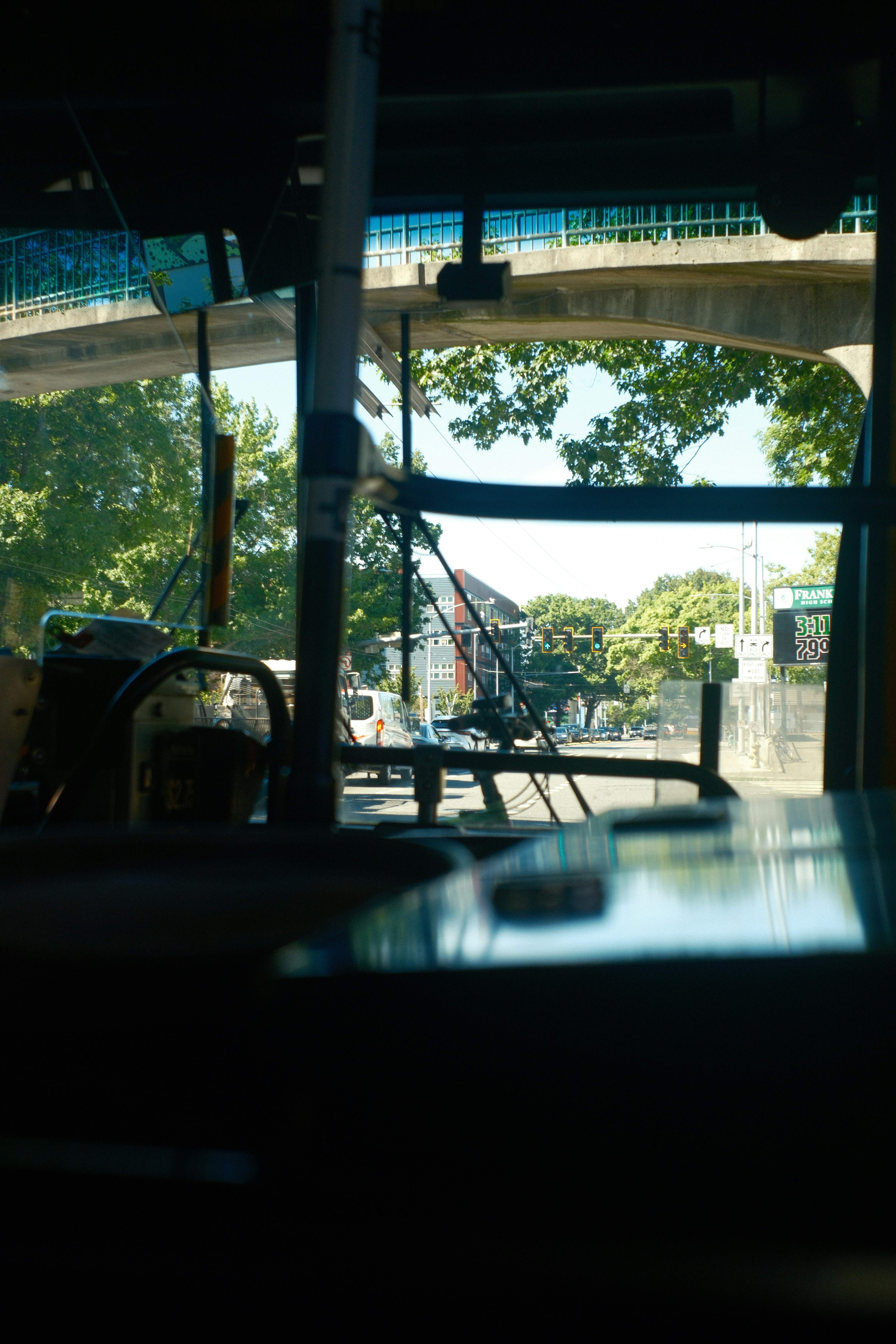 View from bus window of overpass and trees