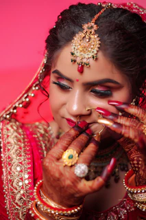 Bride in traditional indian wedding attire with elaborate jewelry.