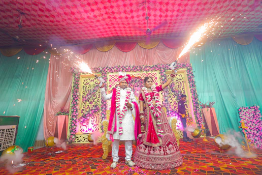 A bride and groom holding sparklers at a wedding