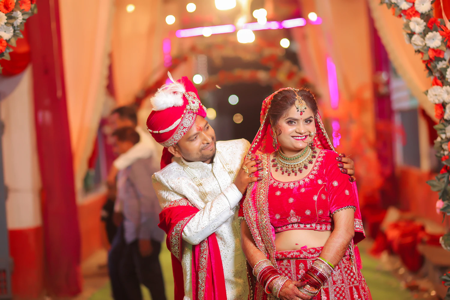 Indian bride and groom celebrating their wedding together in traditional attire