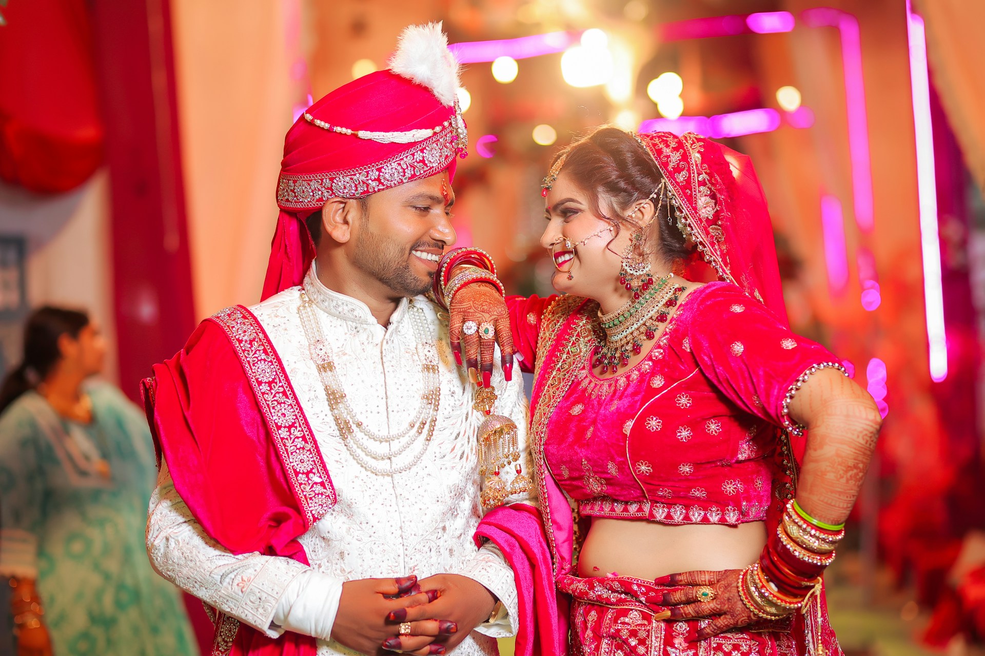 Newlyweds in traditional indian wedding attire smiling