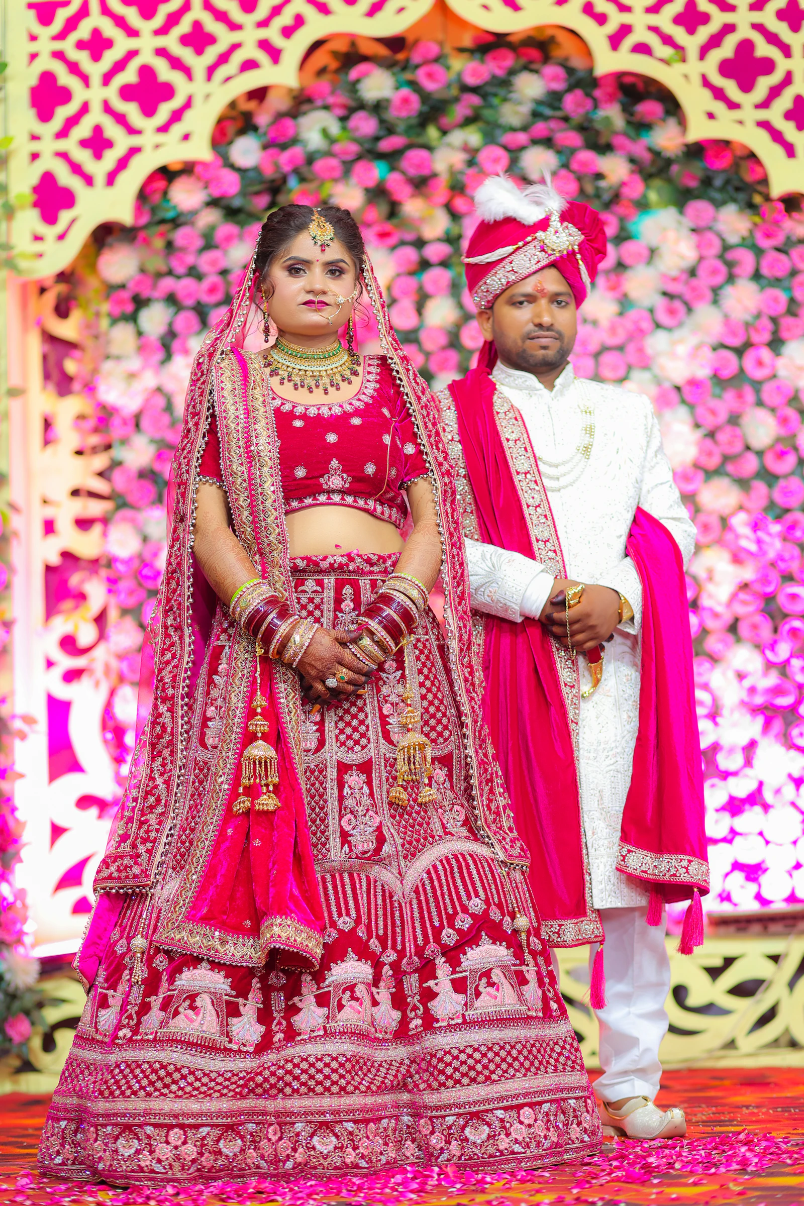 Bride and groom in traditional Indian festive attire celebrating together