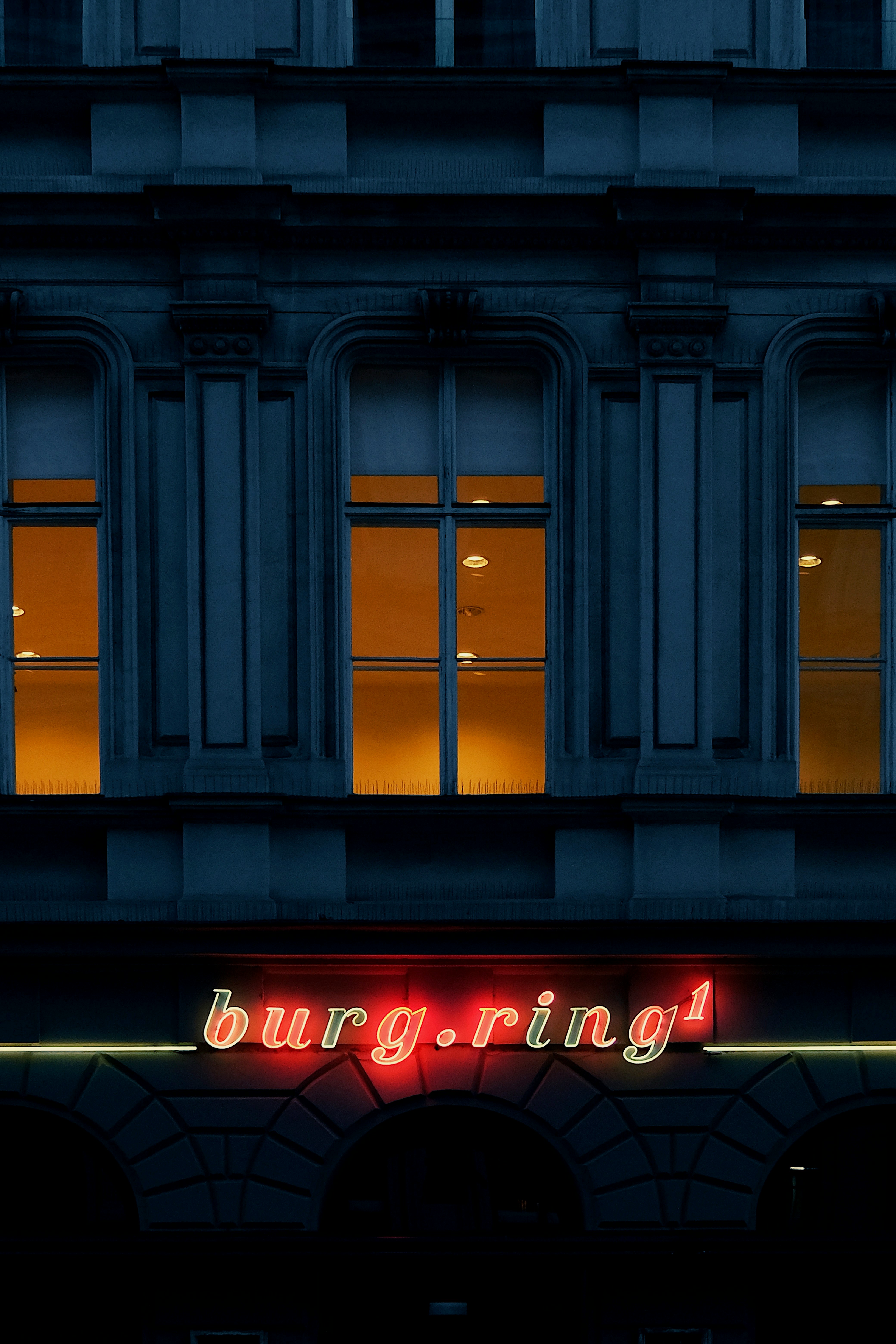 Building facade with glowing neon sign at night