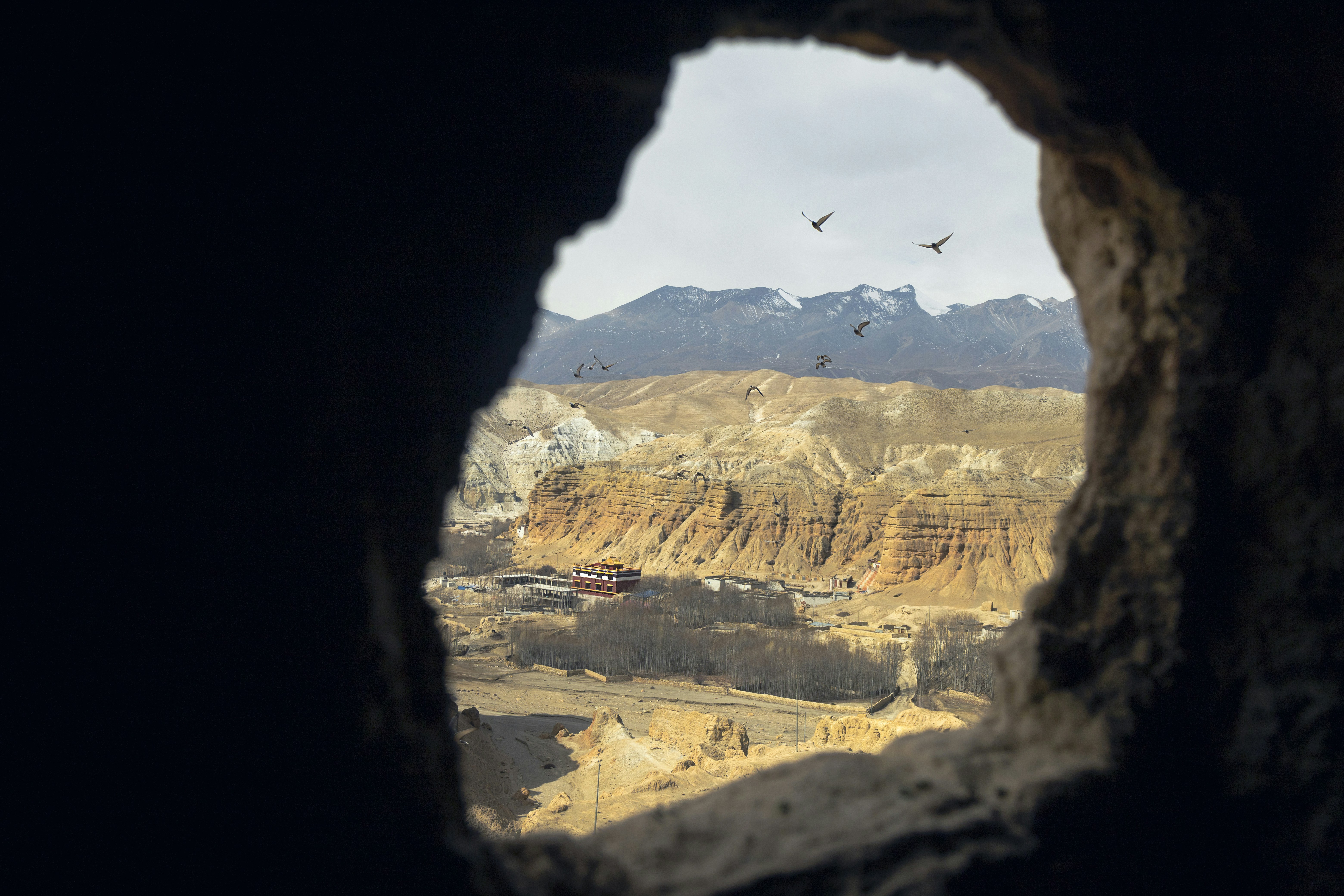 Snow-covered Himalayan ridge under a pale sky