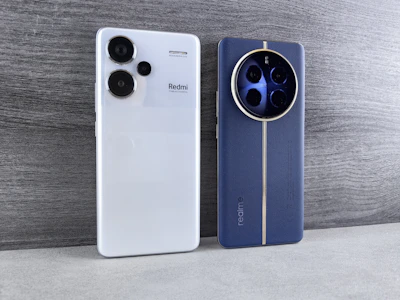 Two smartphones, white and blue, side by side.