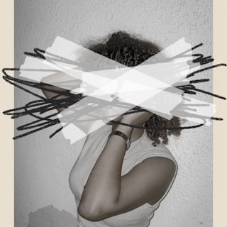 Woman with dreadlocks obscured by abstract shapes.
