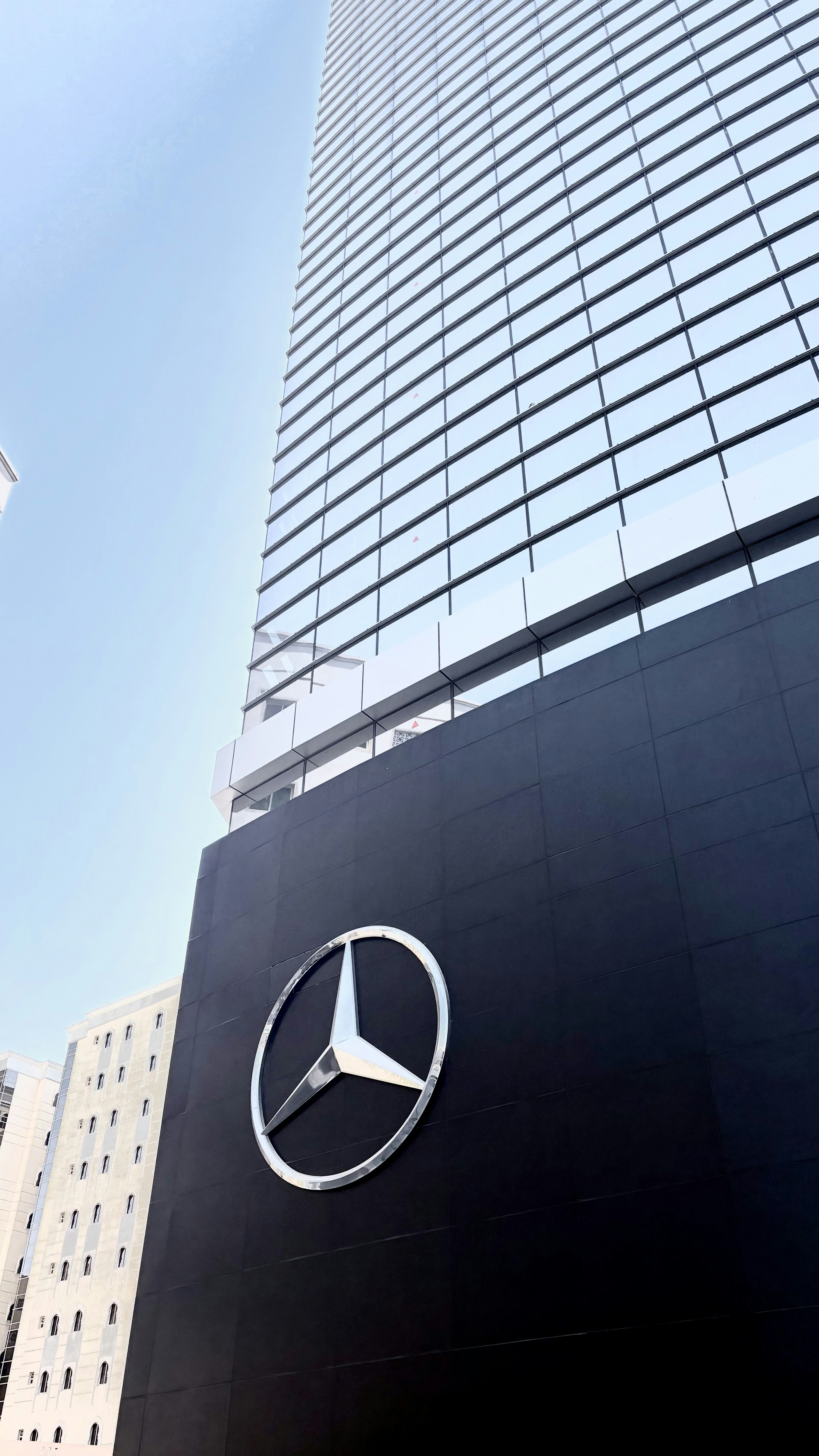 Mercedes-benz logo on a modern building facade