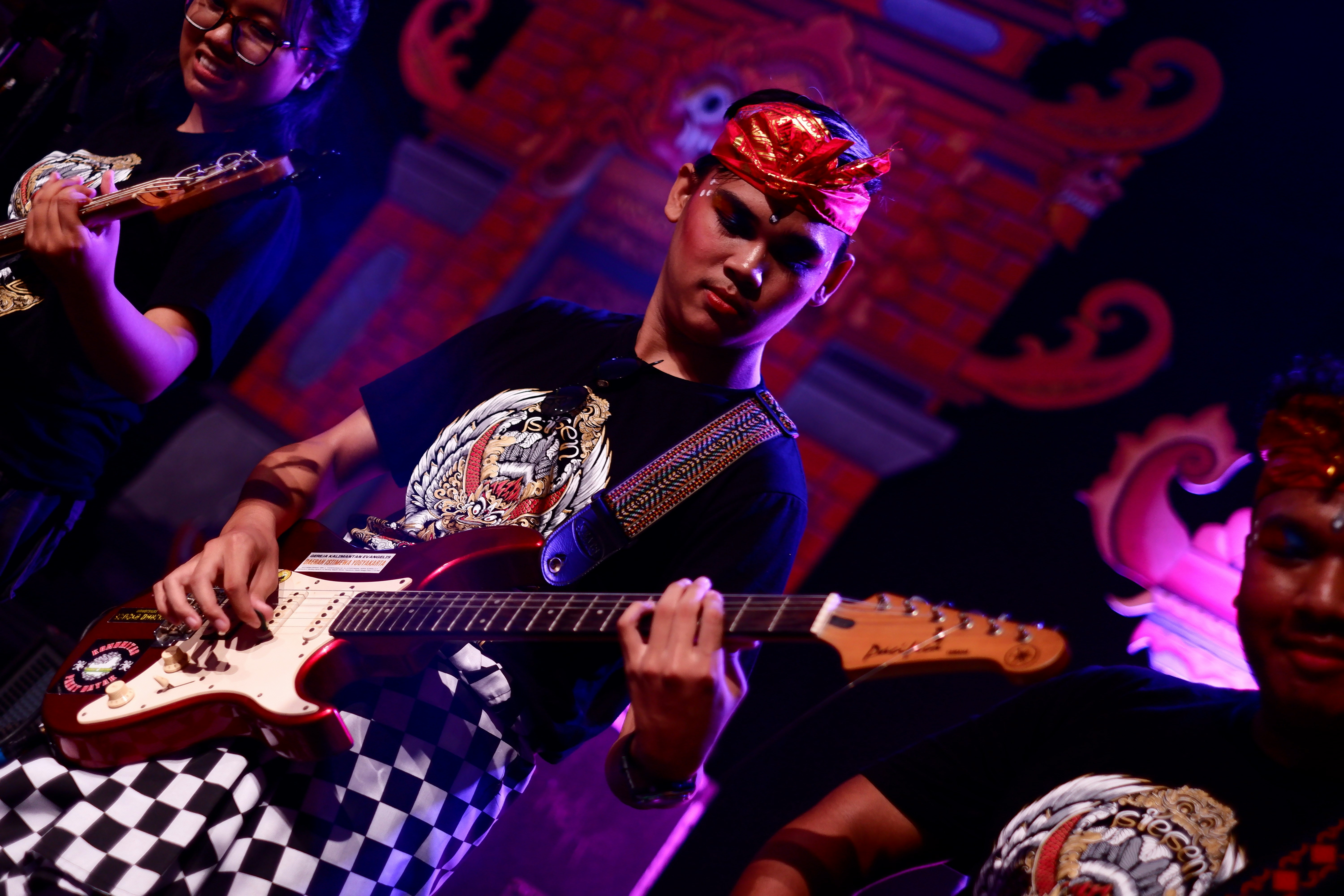 Musicians playing guitars on a stage
