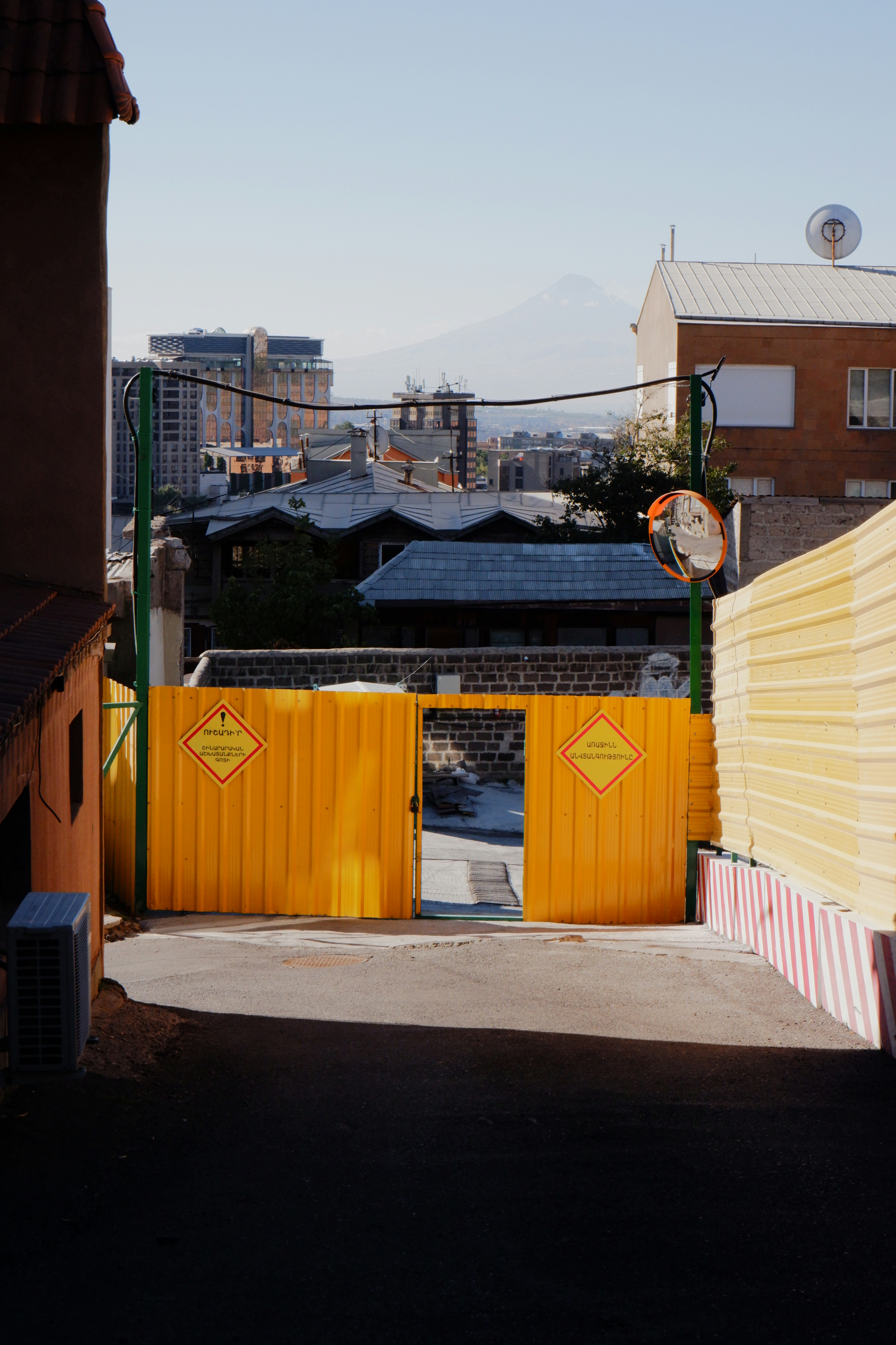 Yellow construction barrier with open gate and mountain view