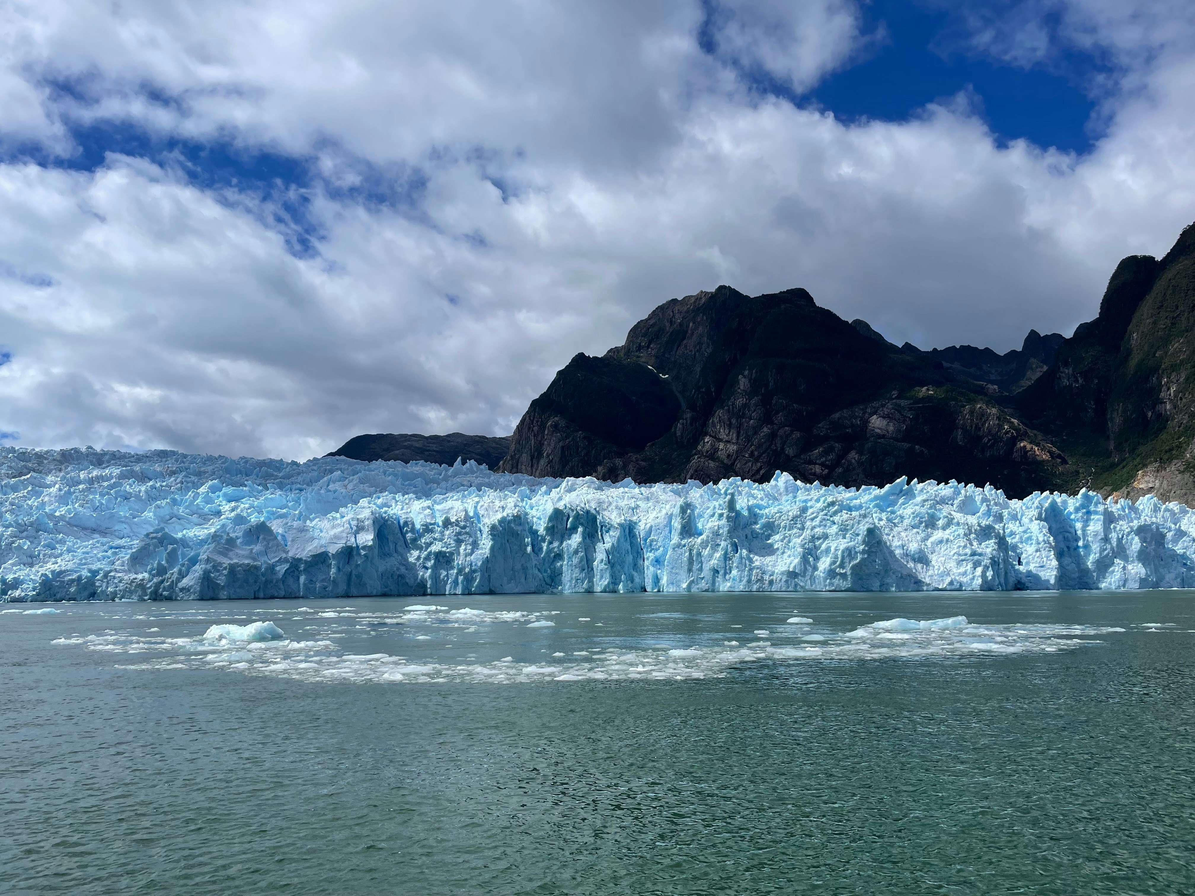 A glacier calving into the water.