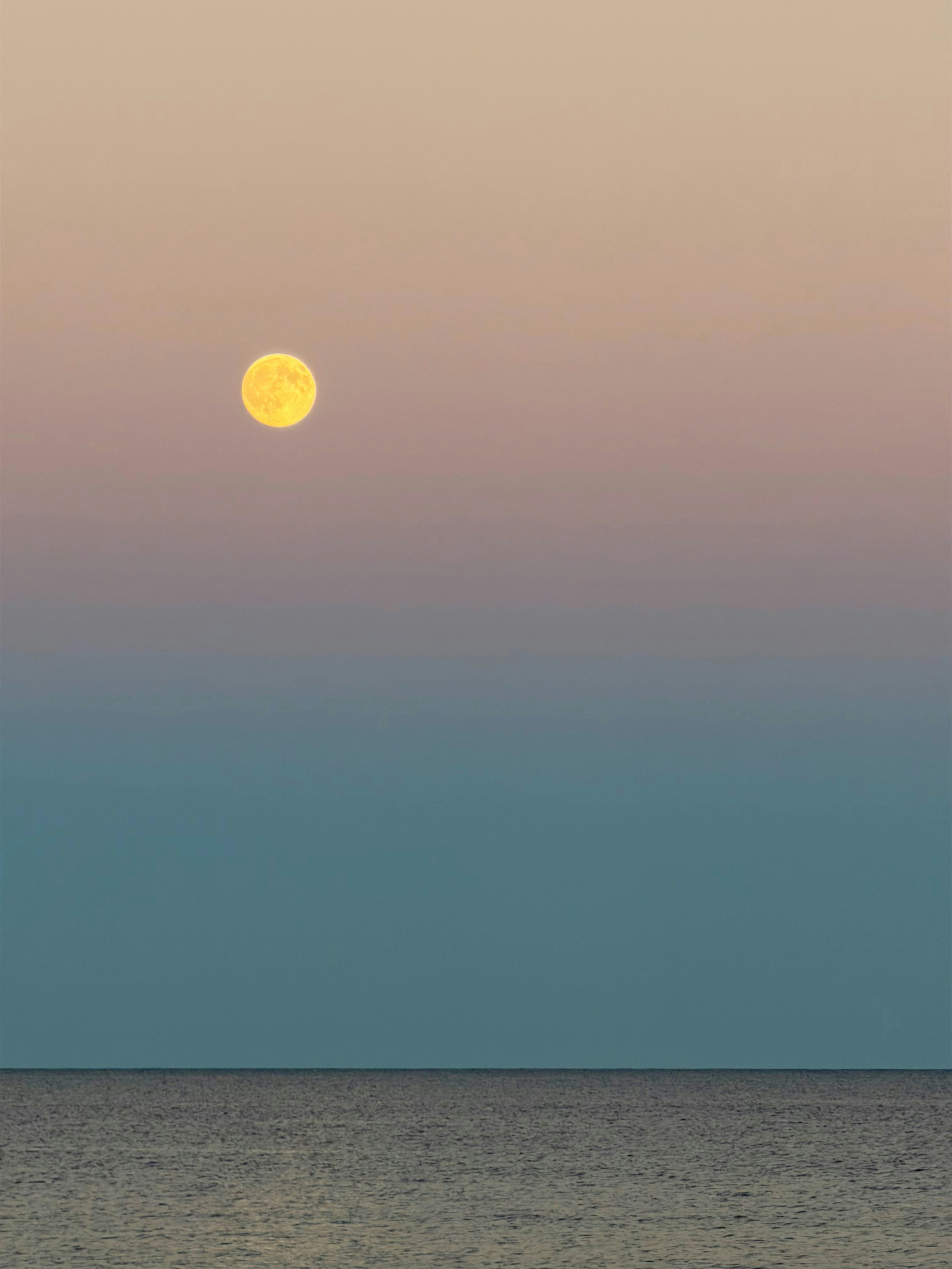 Full moon over the ocean at dusk
