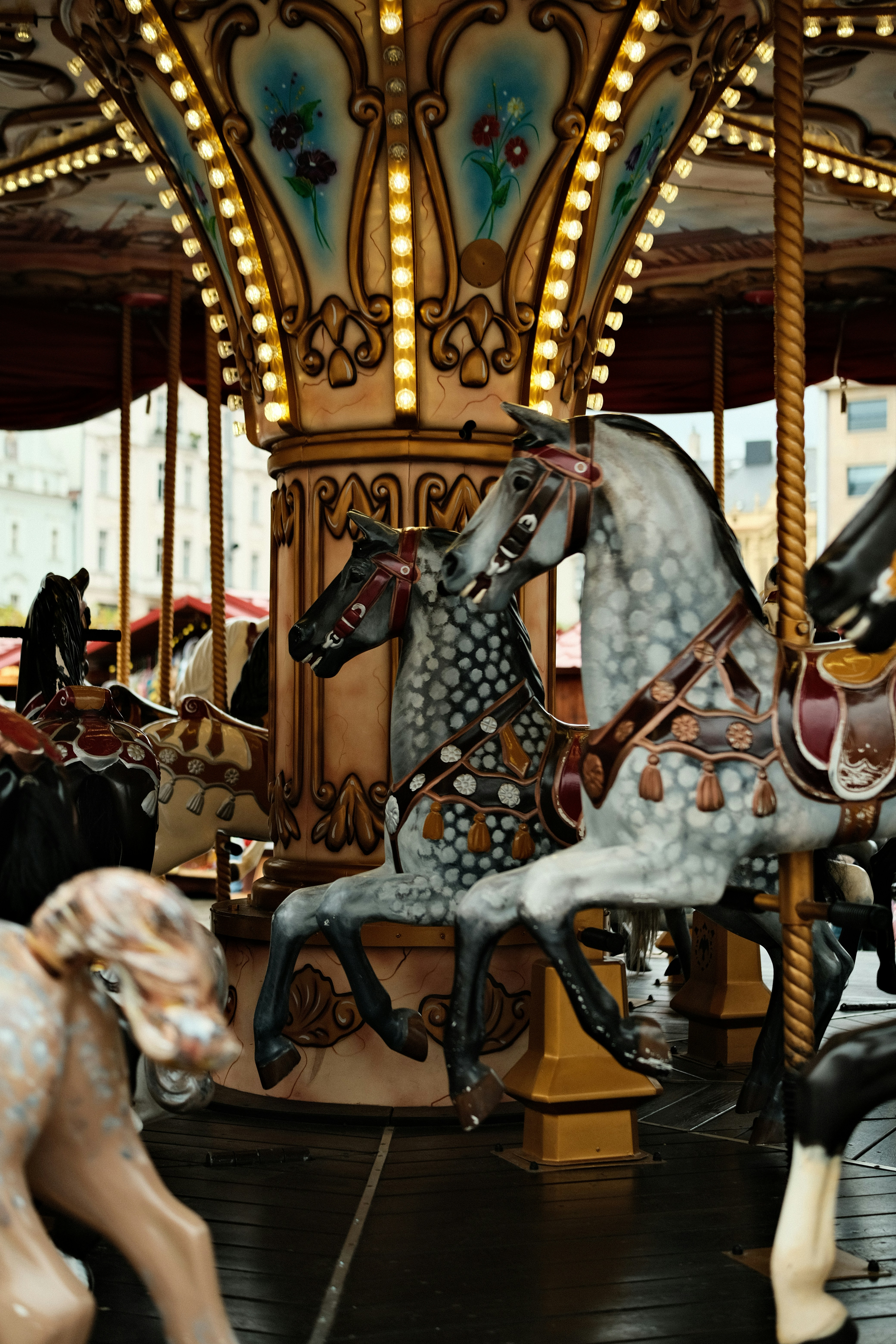 Ornate carousel horses with decorative lights