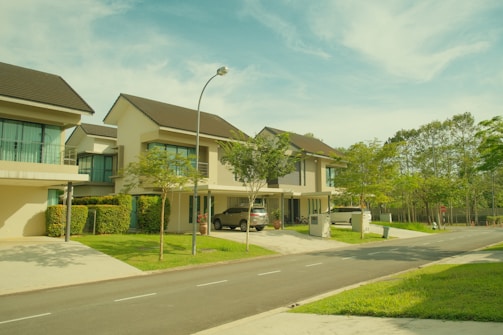 Modern houses on a suburban street with trees.