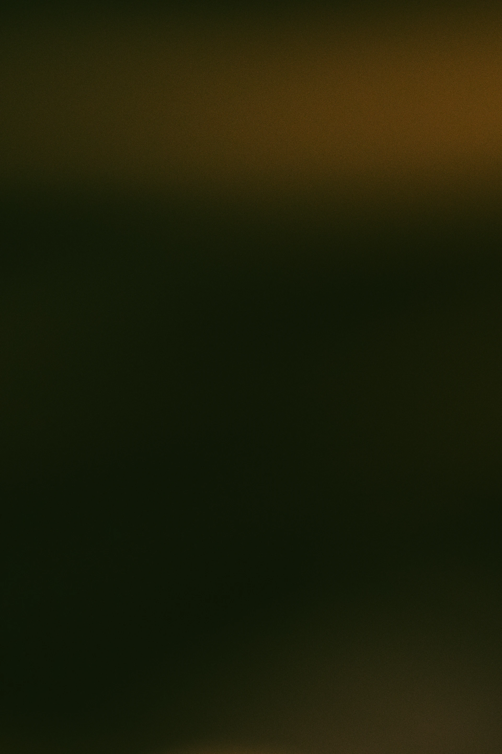 Dark abstract background with subtle warm light.