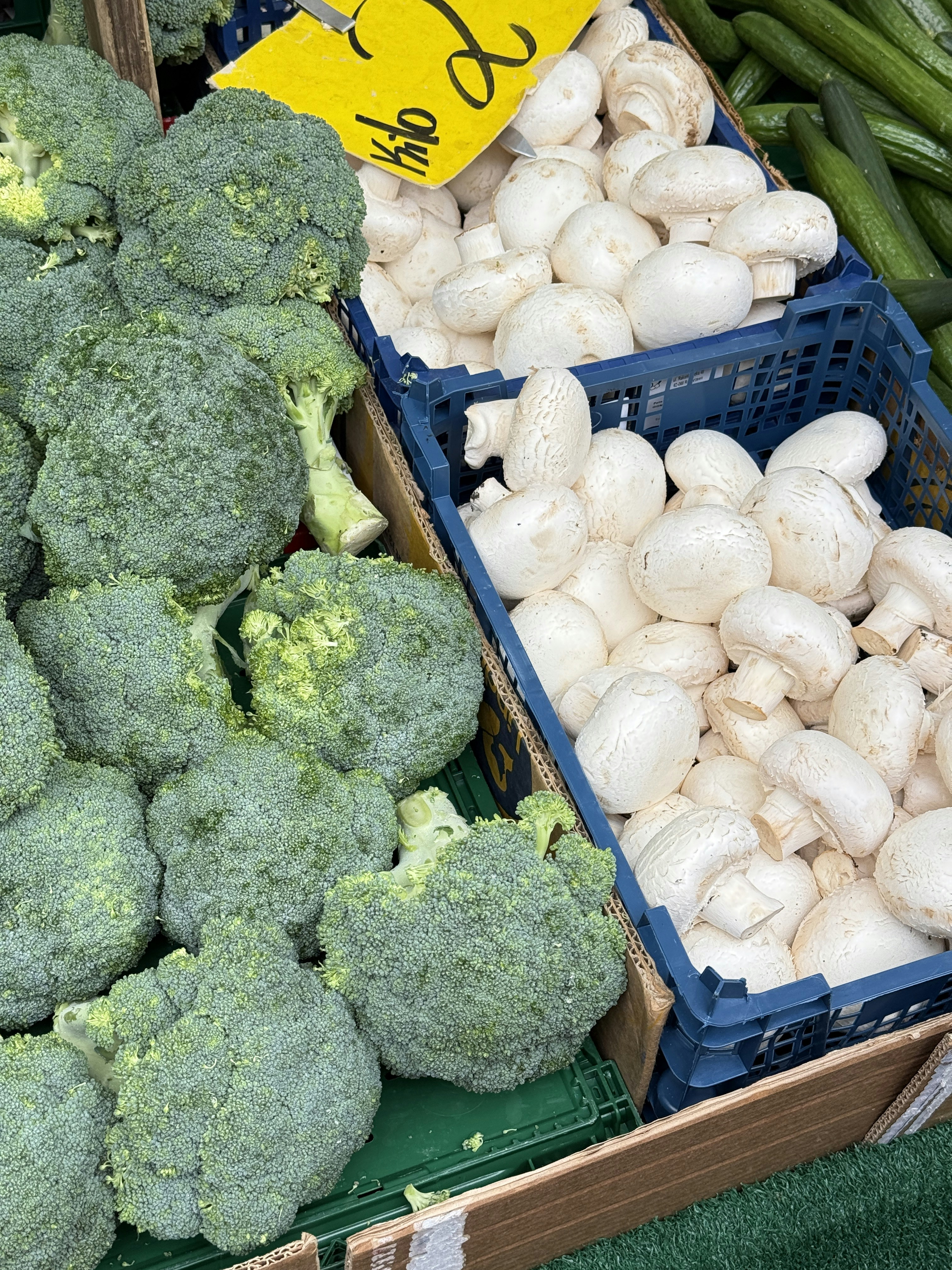 Fresh broccoli and mushrooms at a market.