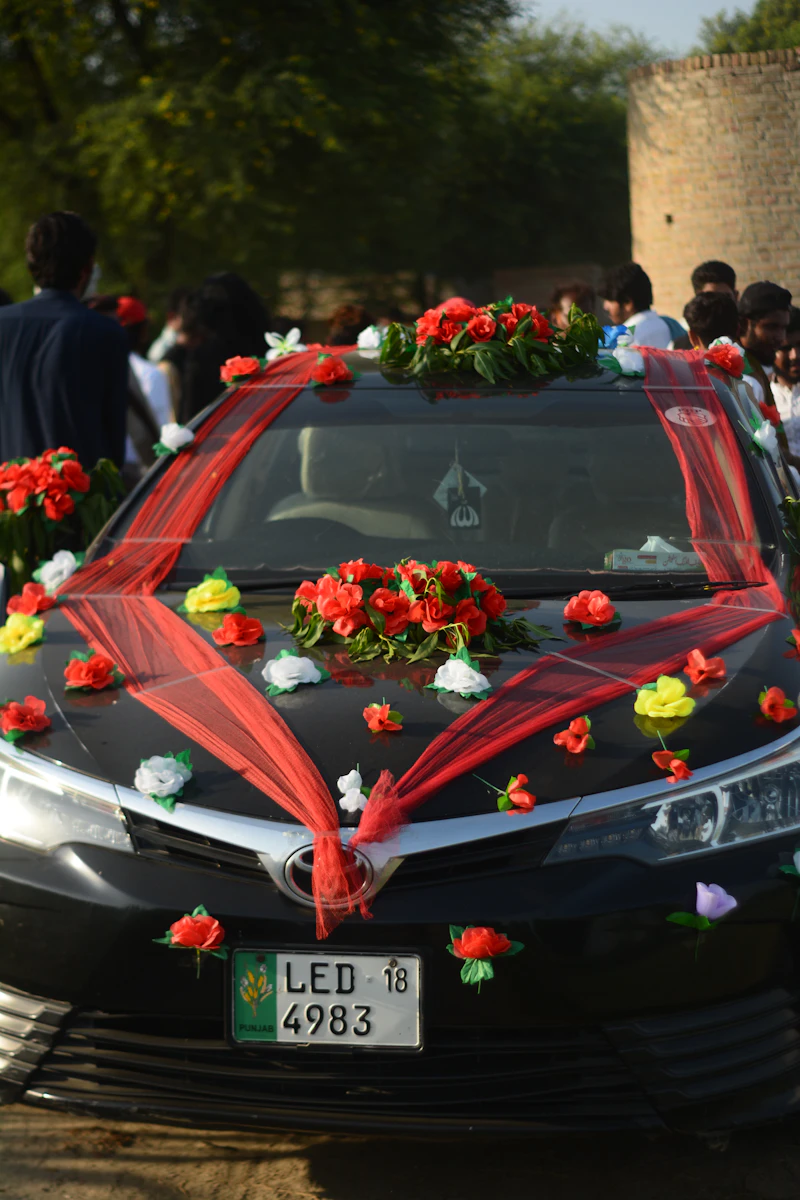 Car decorated with red and white flowers