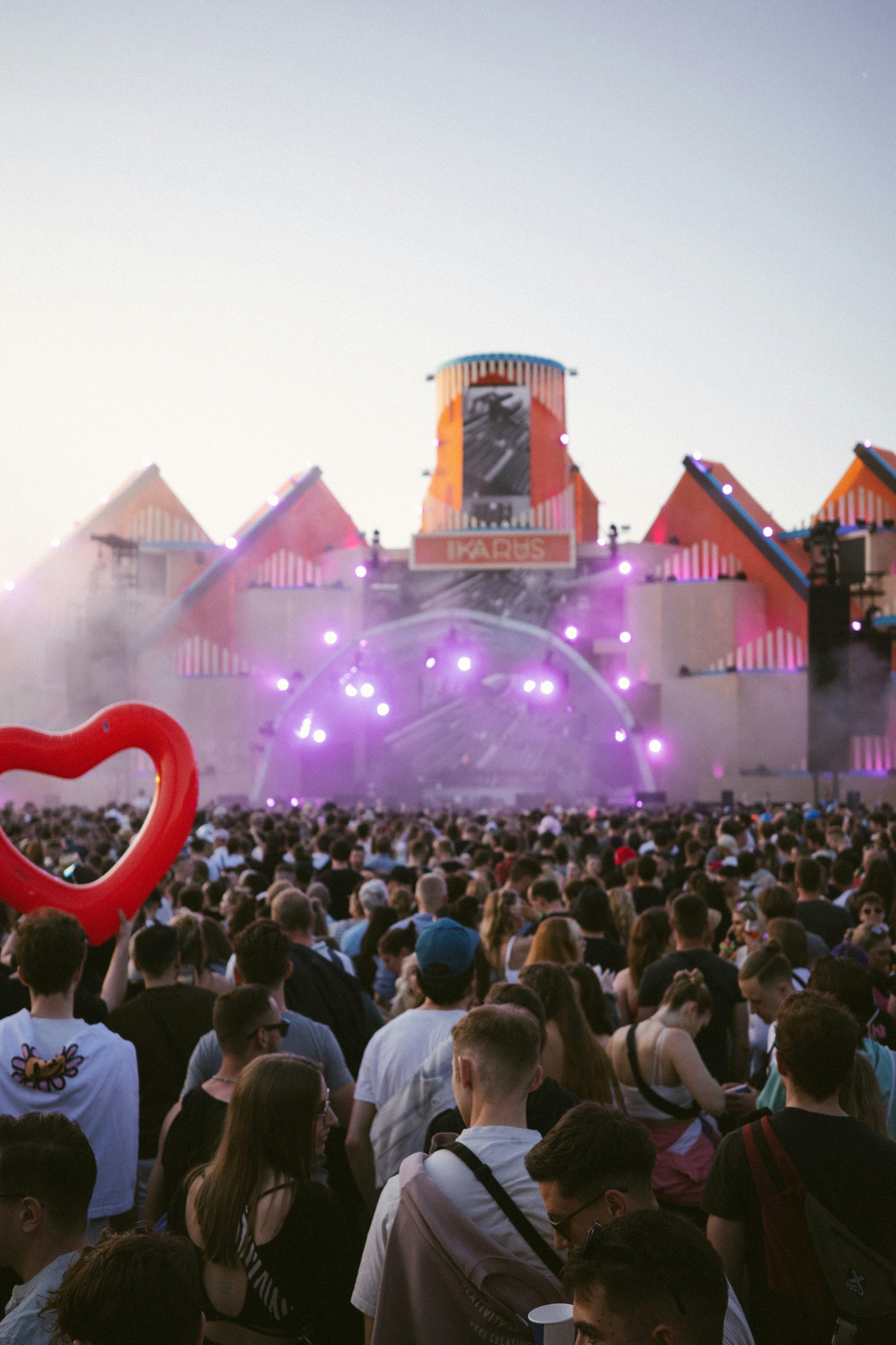 Outdoor music festival crowd facing a stage (stock photo)
