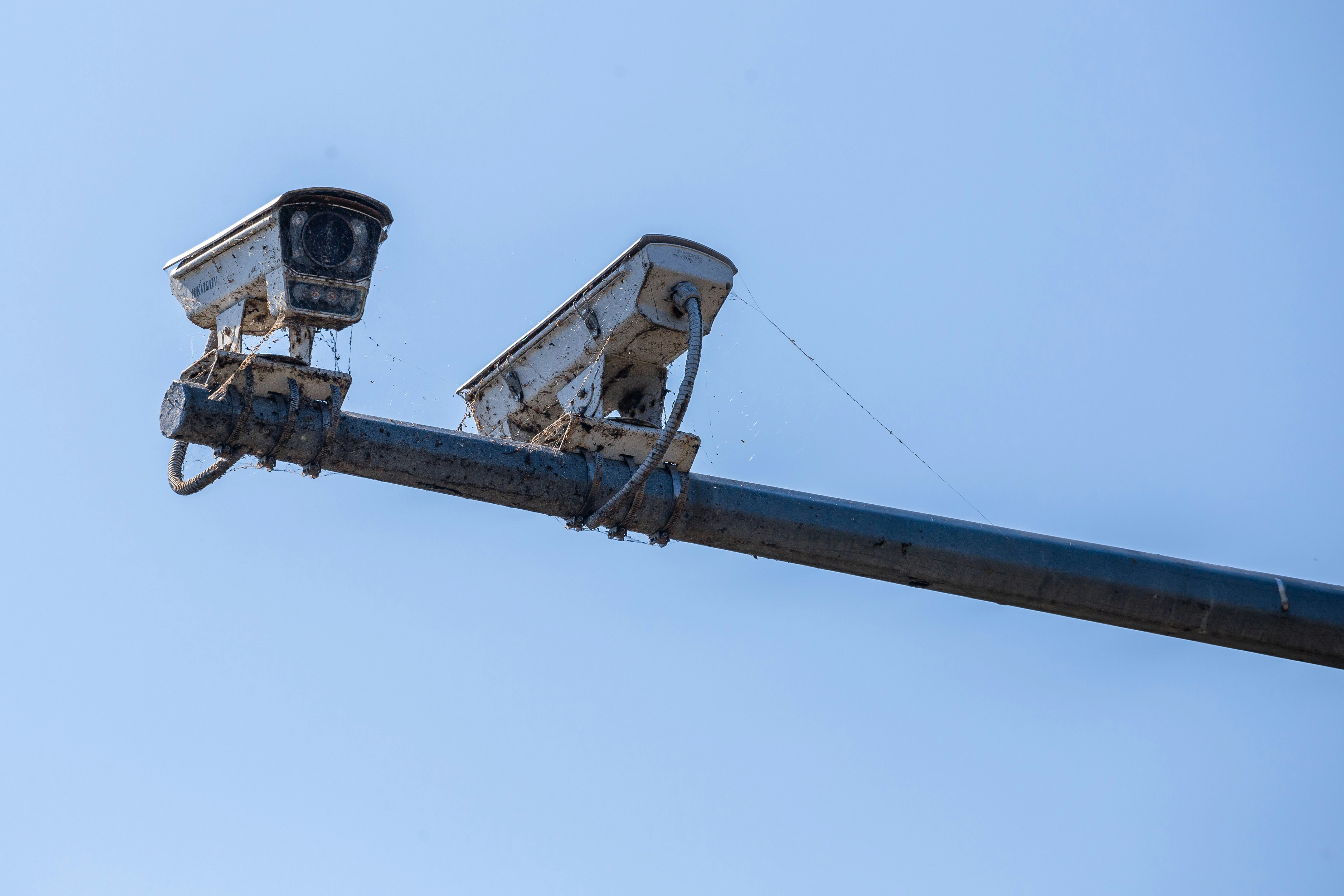 Two security cameras mounted on a pole