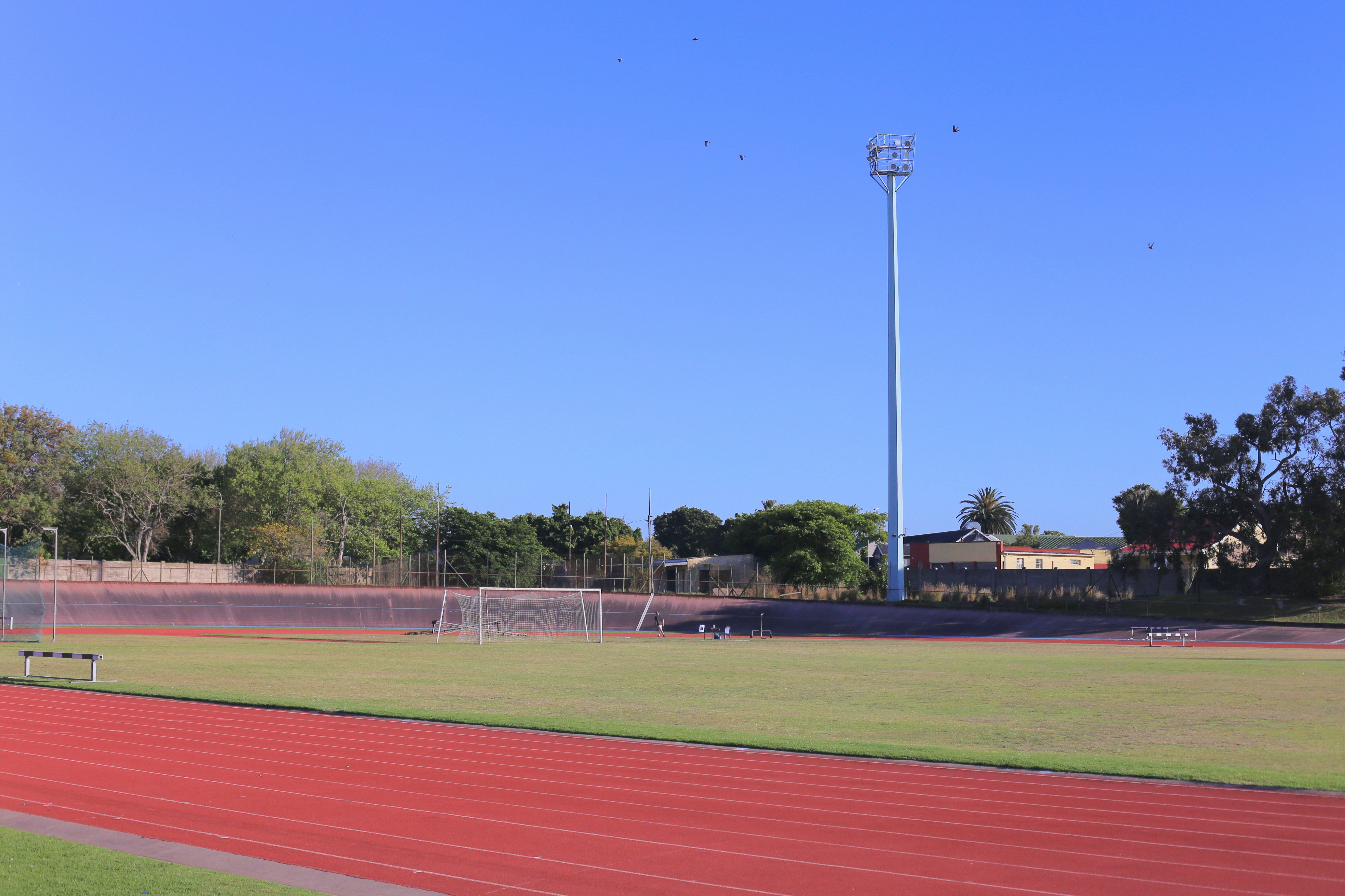 Running track and soccer field under clear blue sky