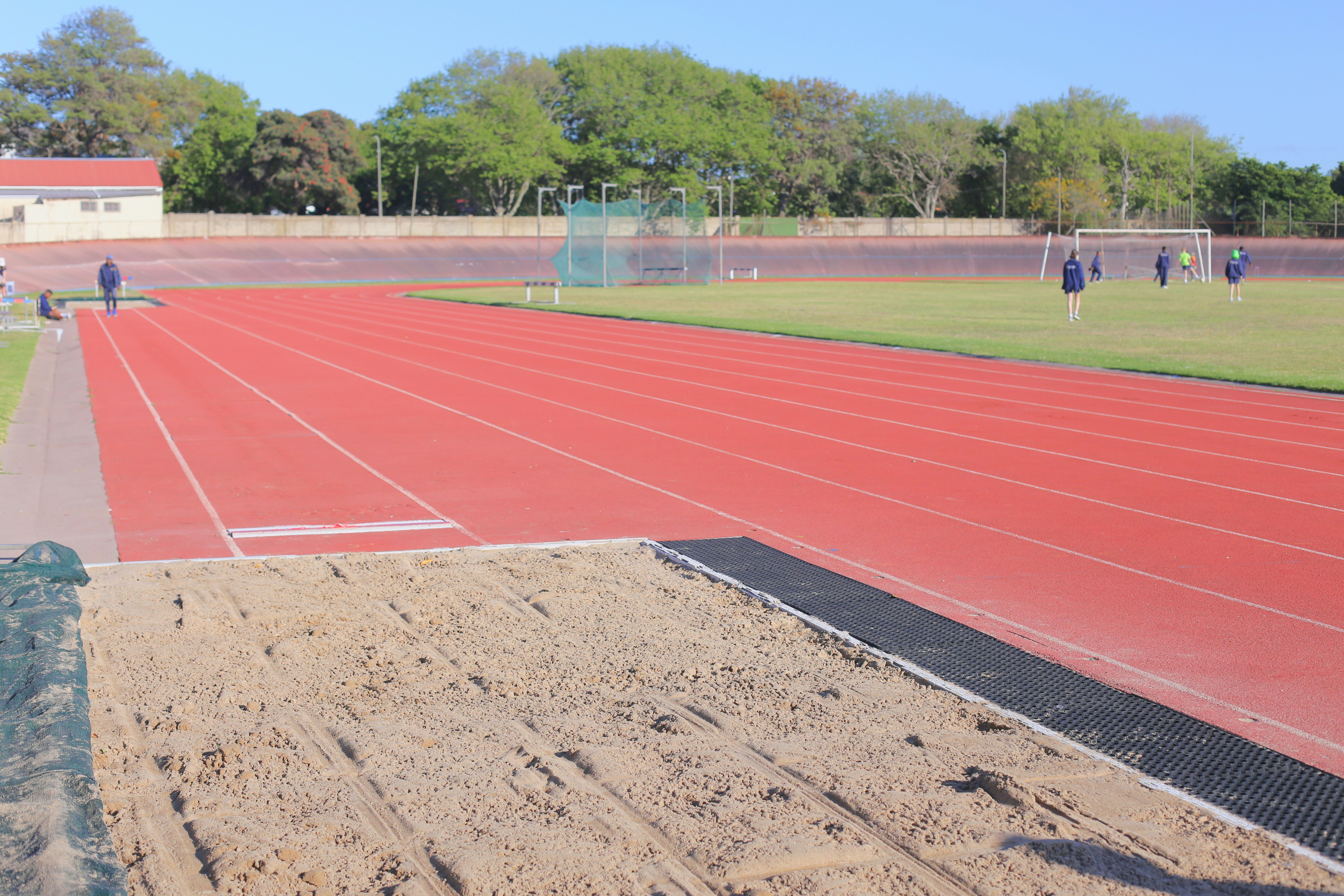Athletes on a running track and sand pit