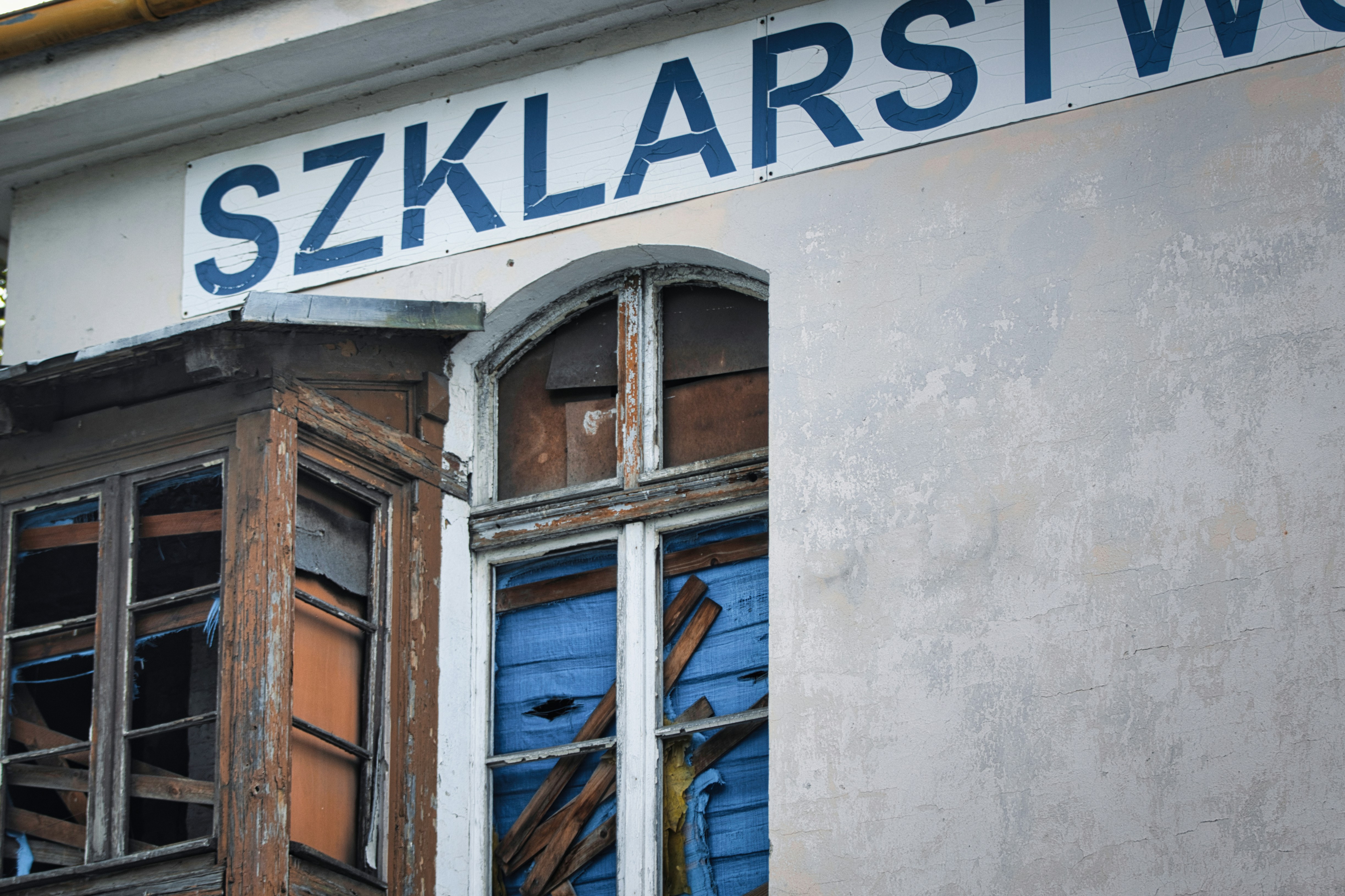 Old building with broken windows and sign