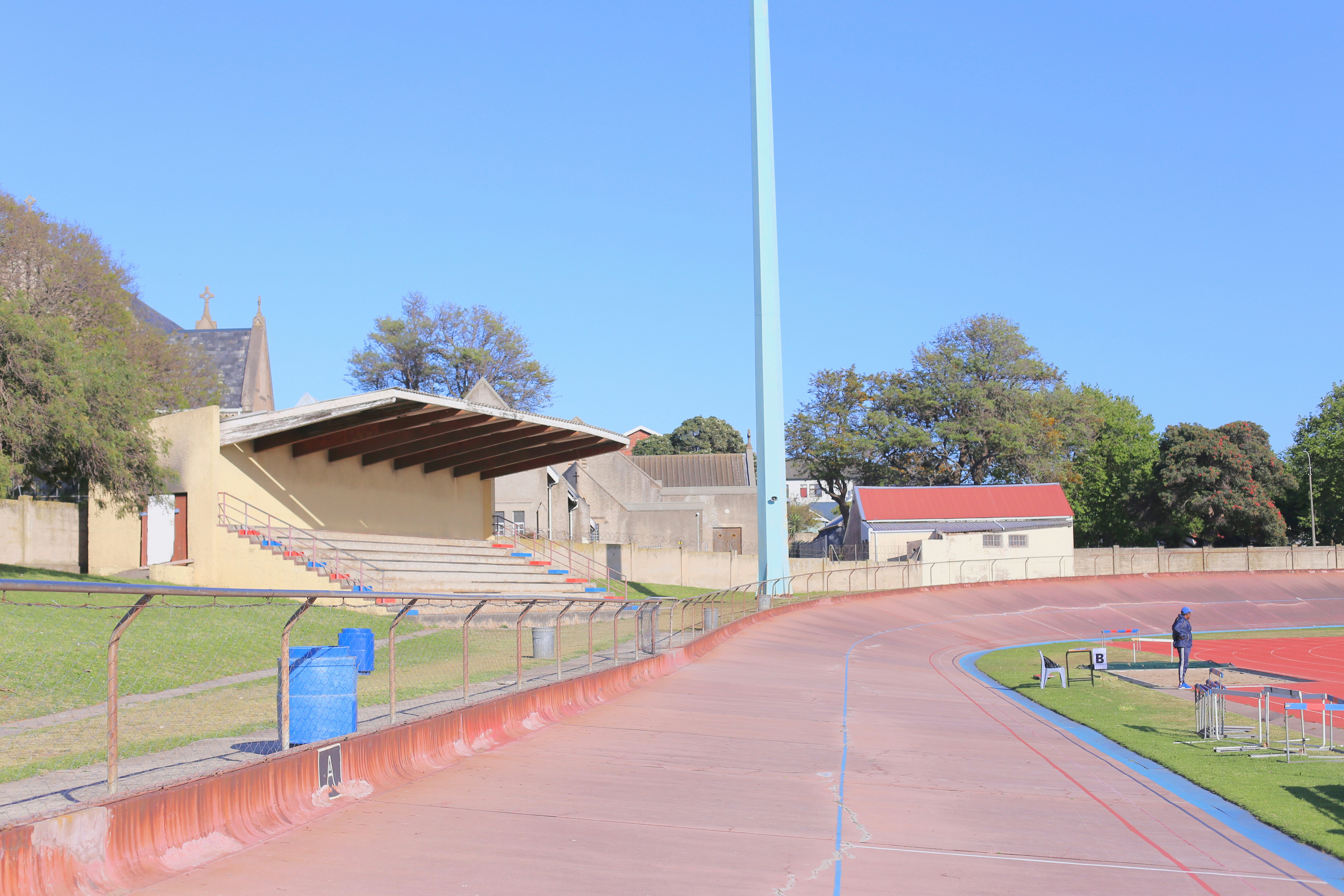 Outdoor velodrome with grandstand and blue sky