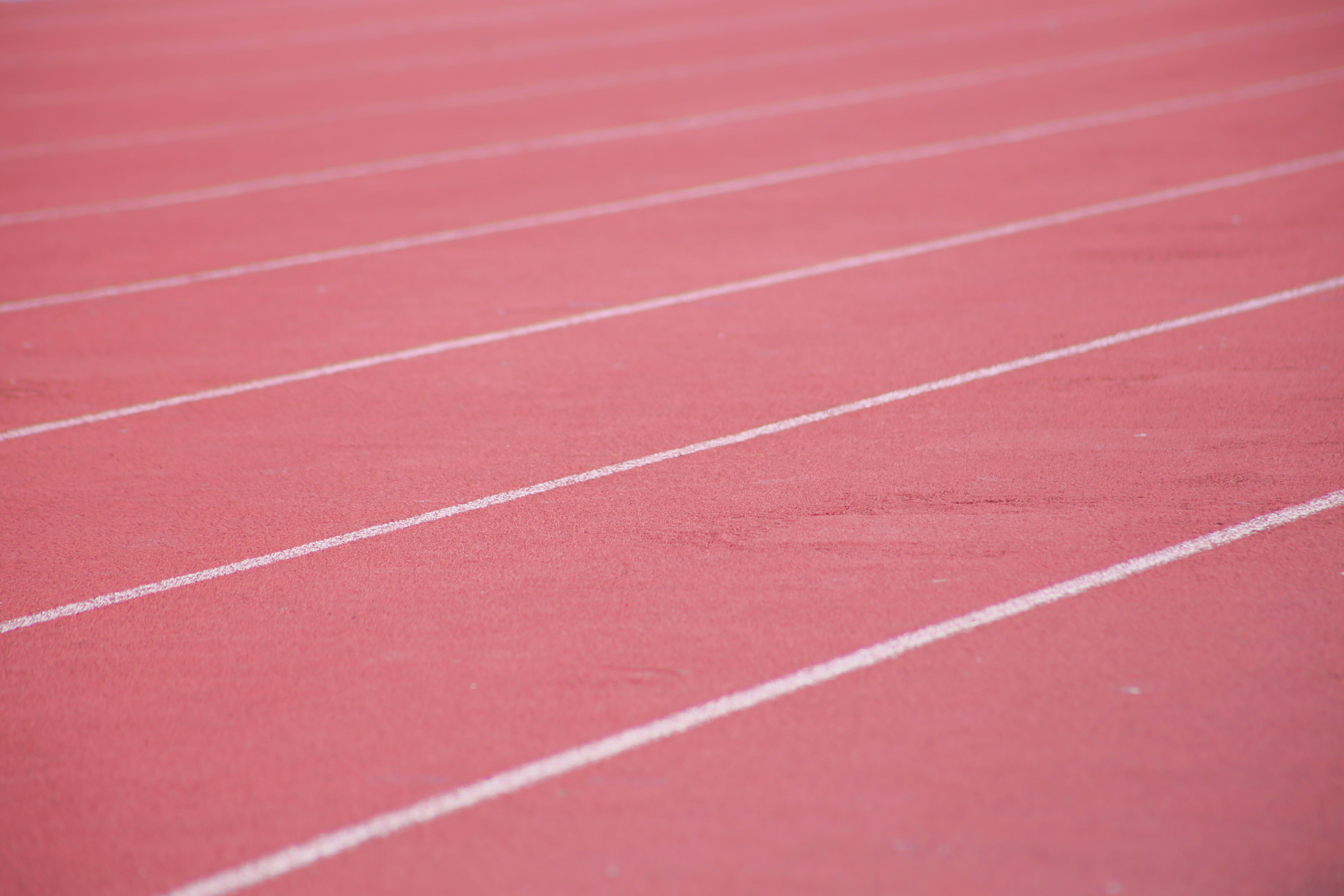 Red running track with white lines