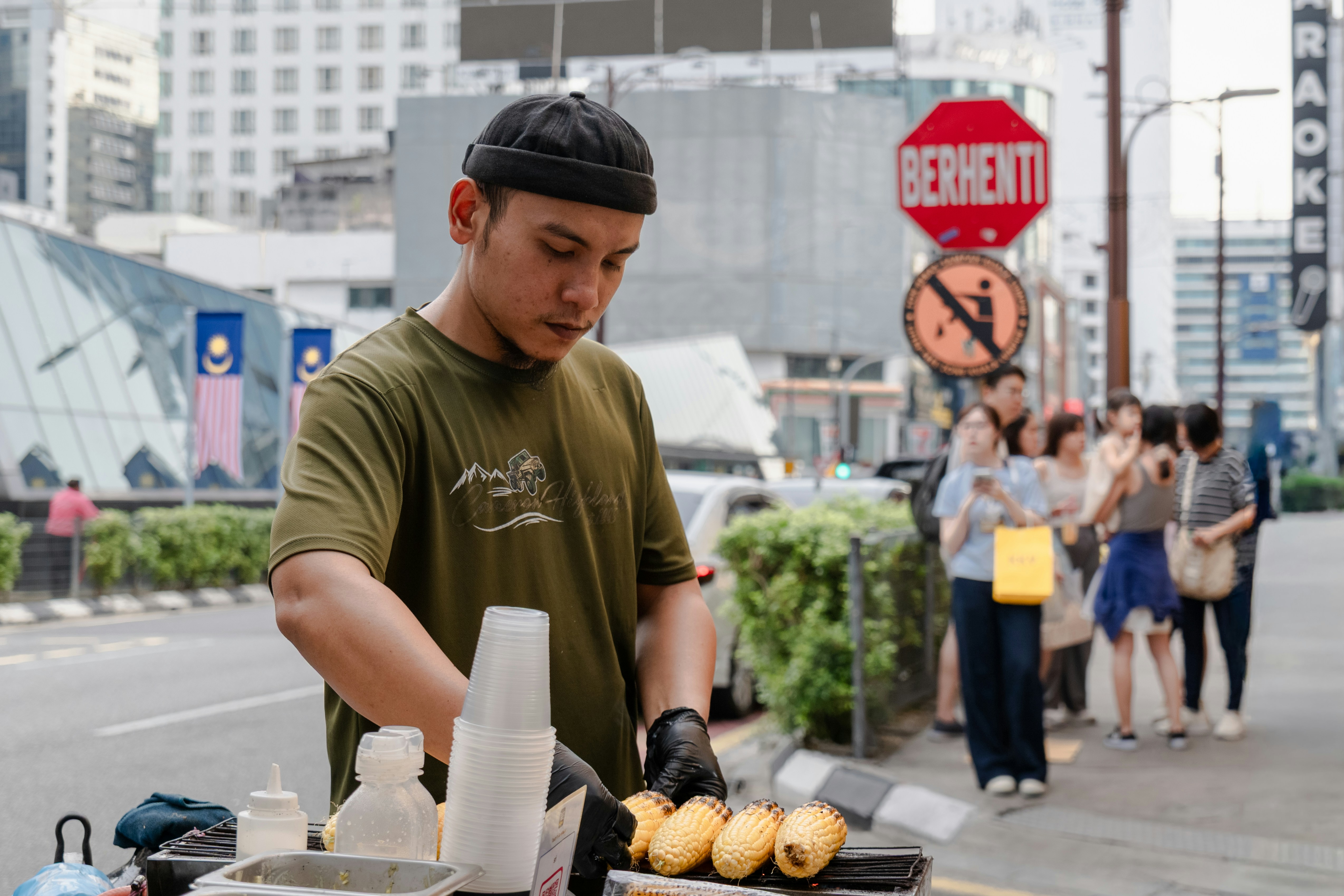 Man preparing food at an outdoor street stall.
