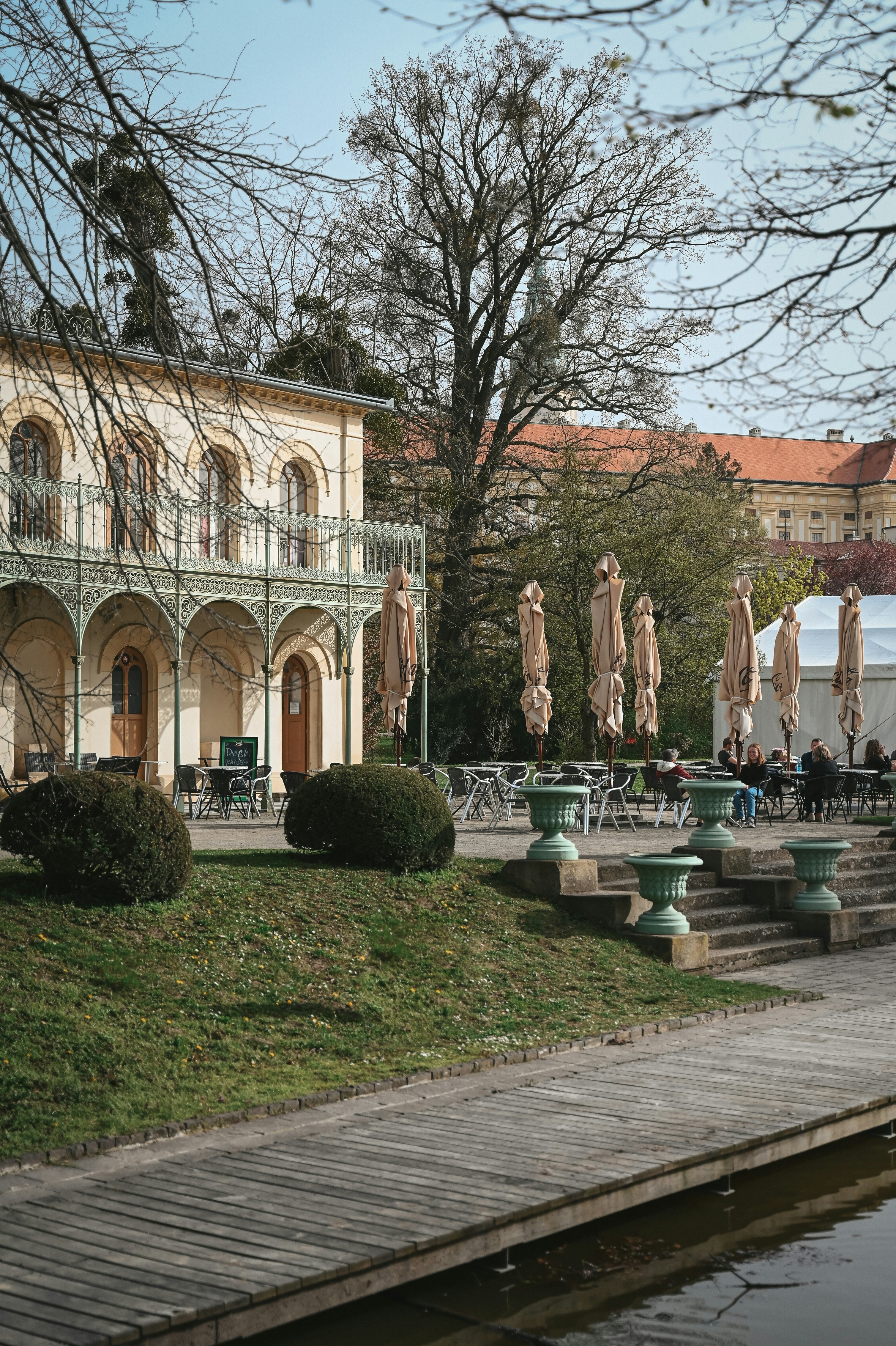 Outdoor cafe tables and chairs beside a building.