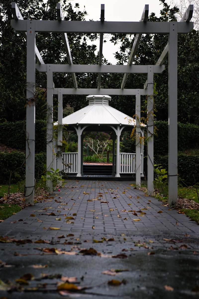 Gazebo bianco alla fine di un vialetto in giardino