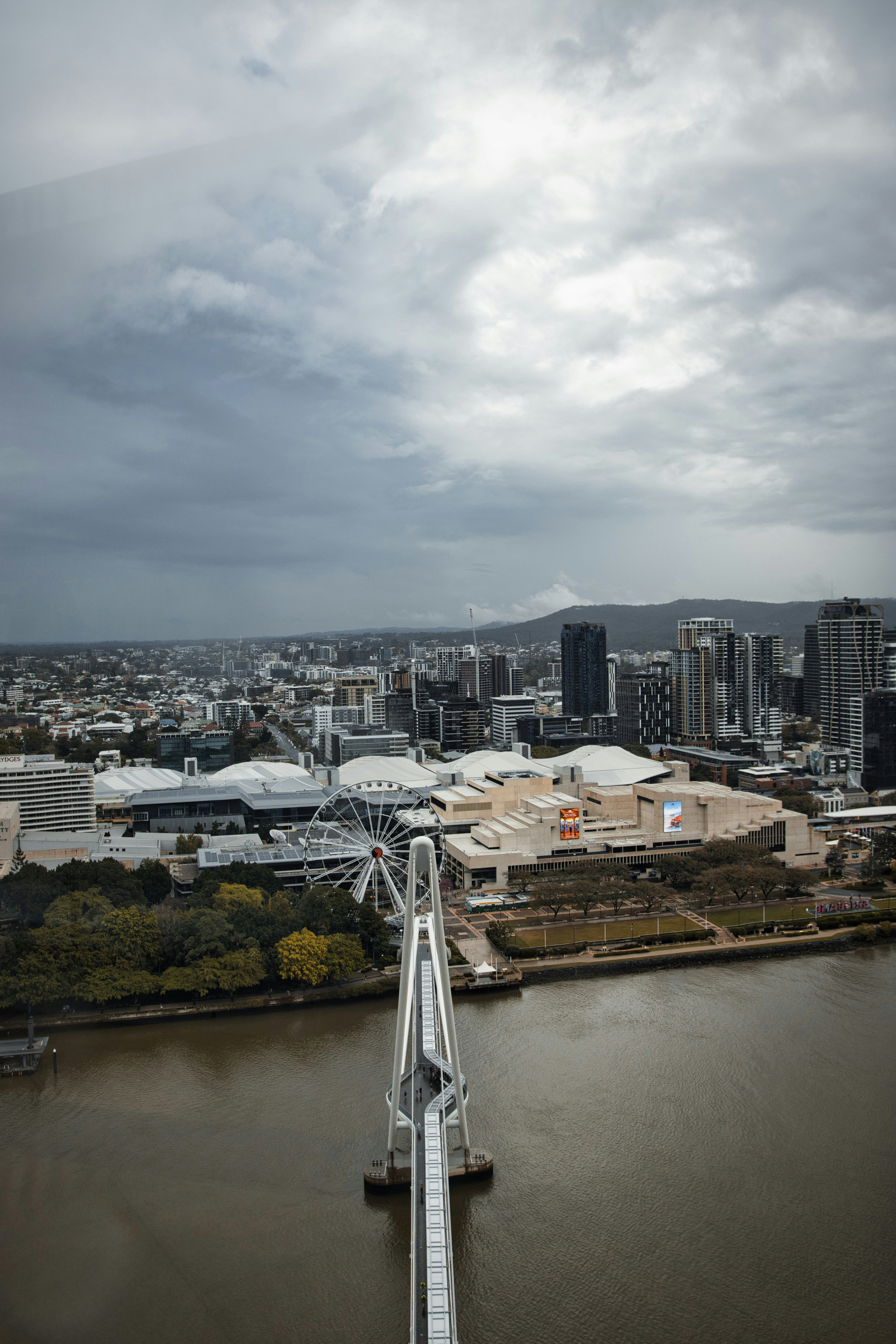 City skyline with a bridge over a river.