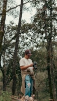 Man holding a camera in a forest