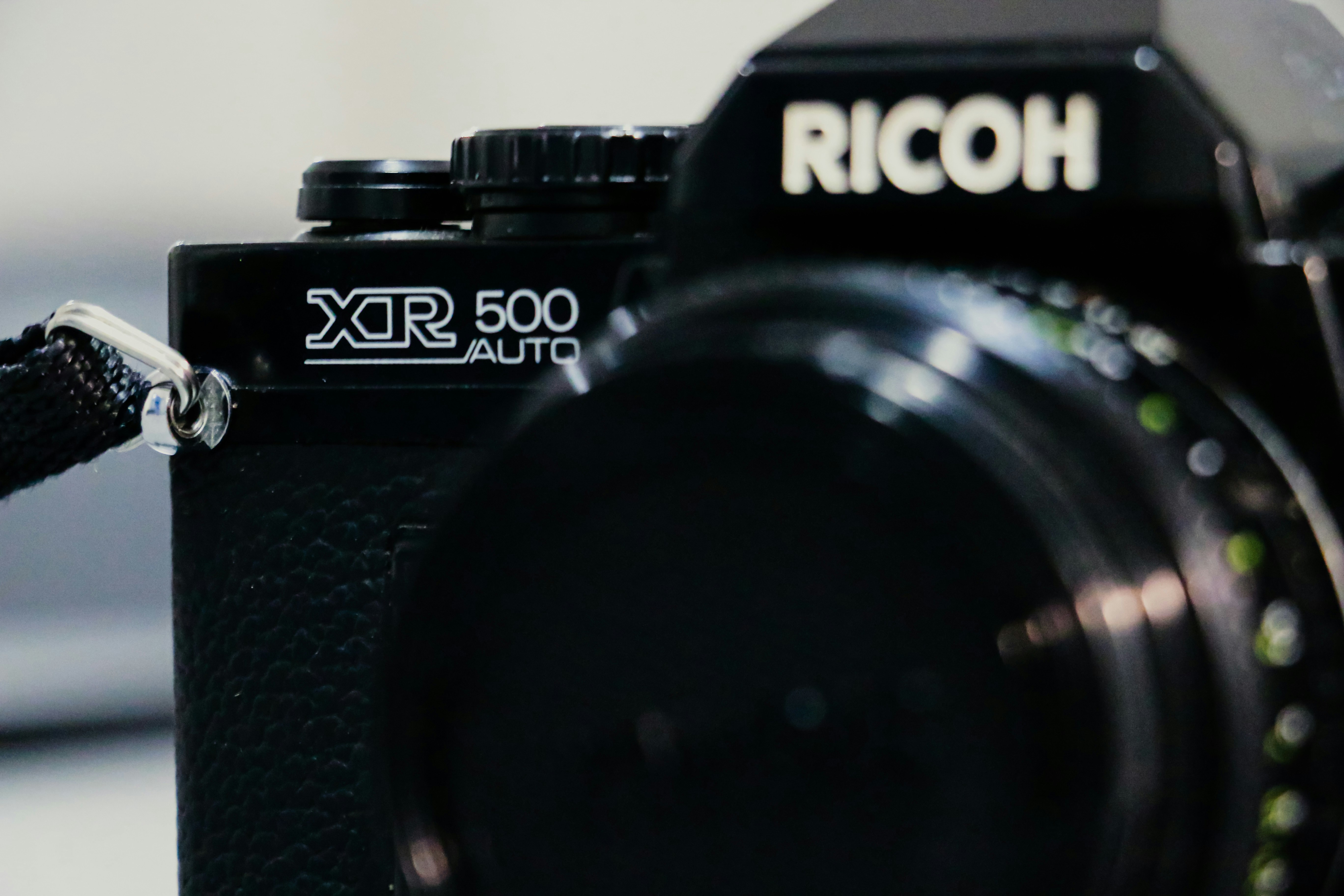 Close-up of a black ricoh xr 500 auto camera.
