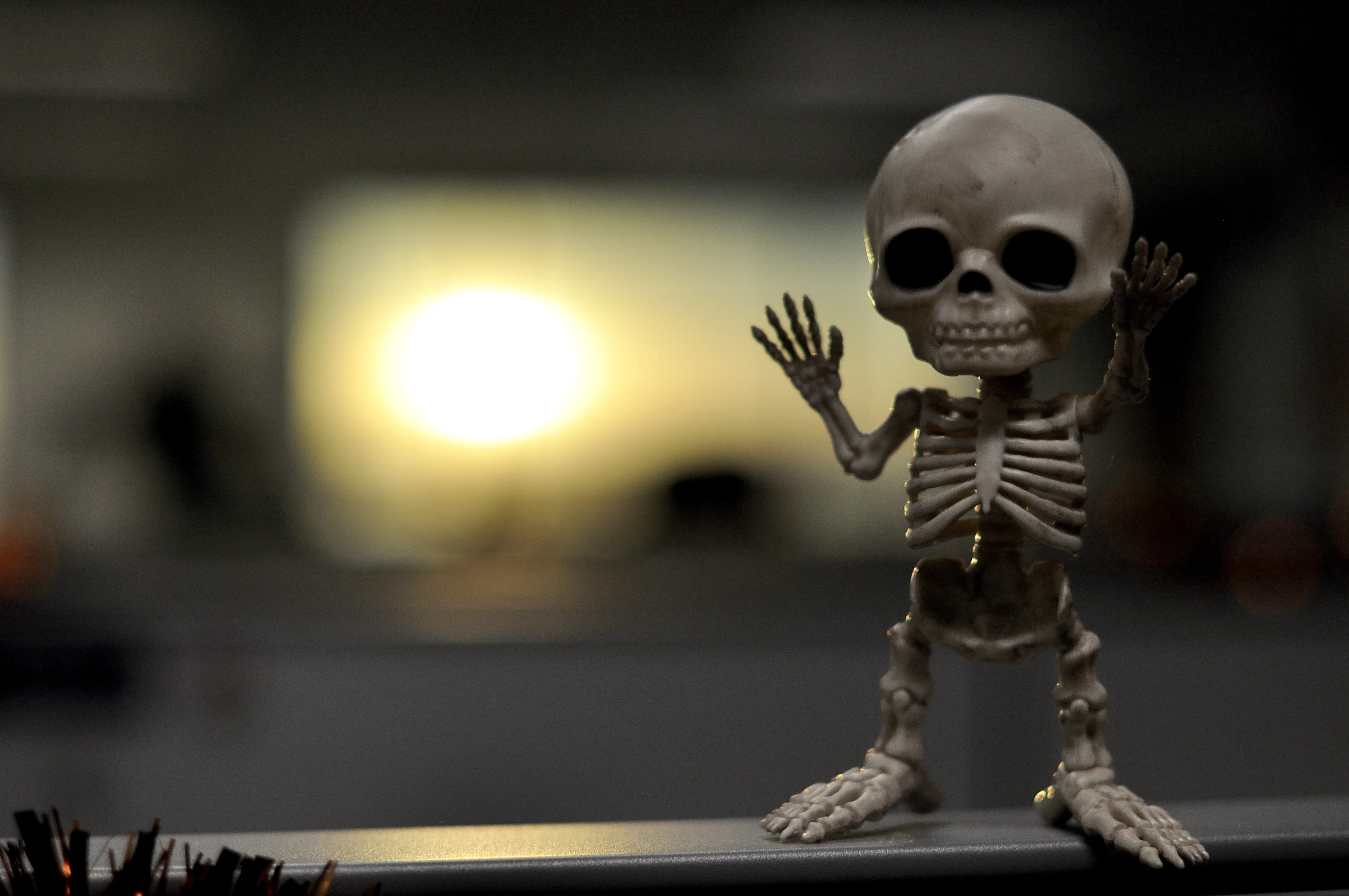 A small skeleton figure with big eyes dances.
