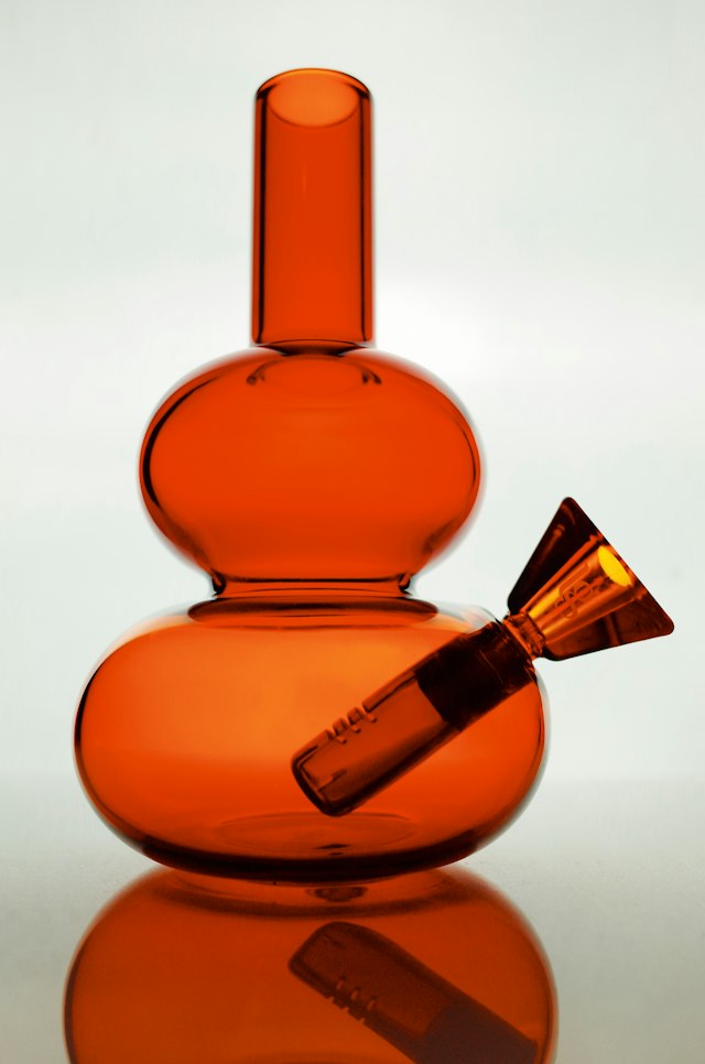 Orange glass water pipe on a white background