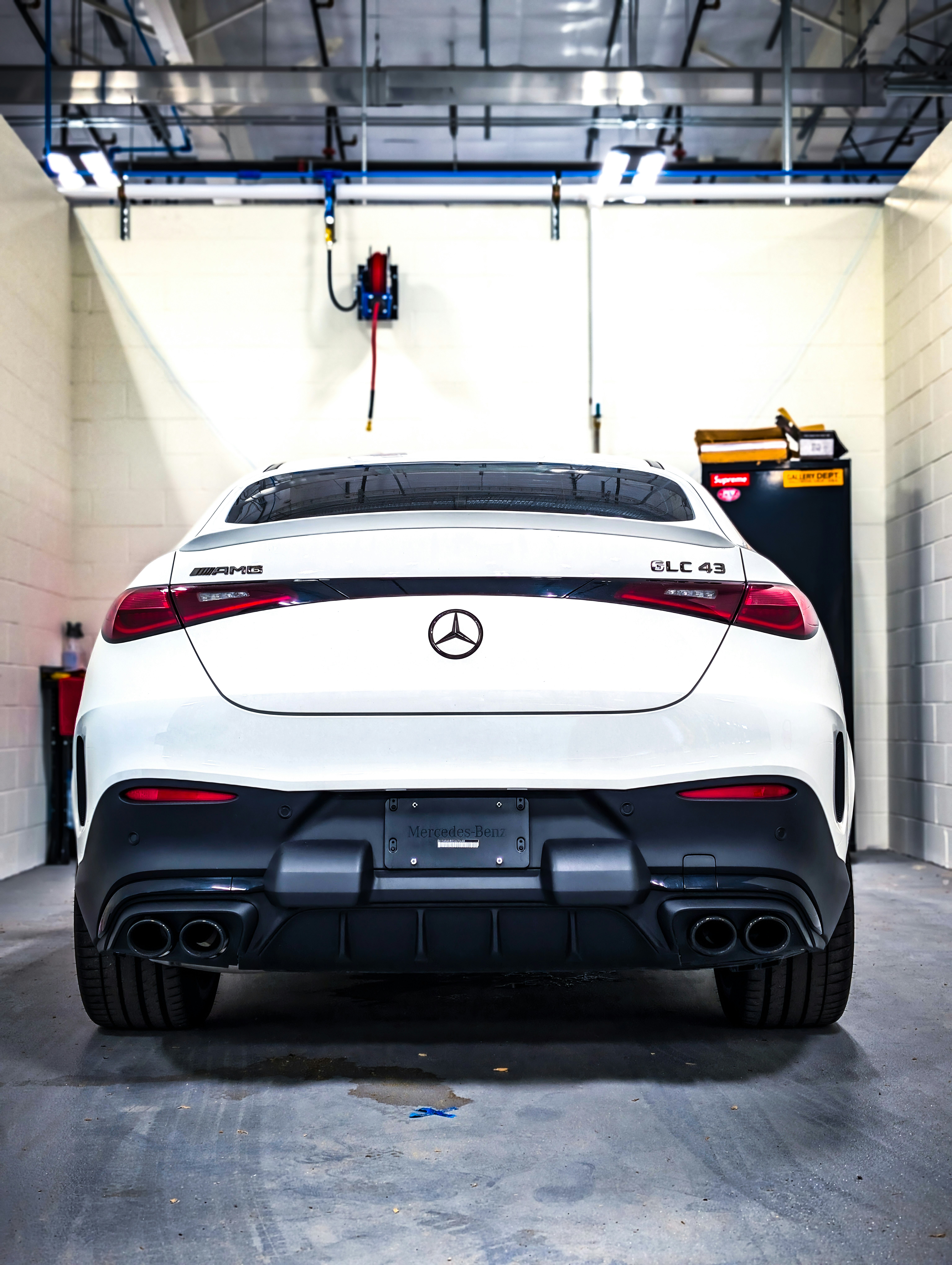 White SUV in an indoor detailing bay