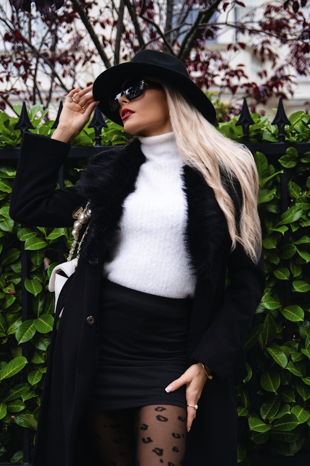 Woman in black coat and white sweater
