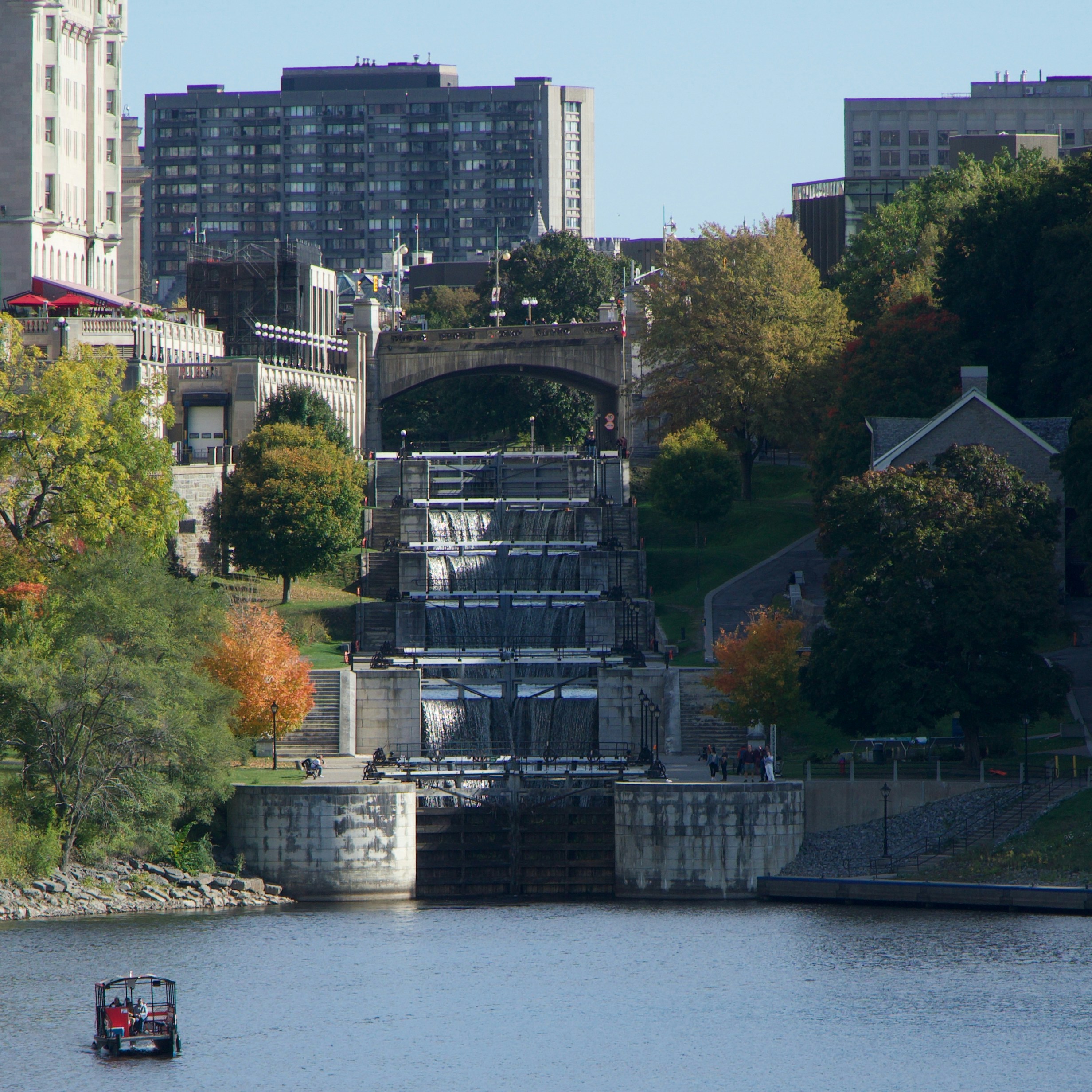 Water cascades down stone locks with buildings beyond