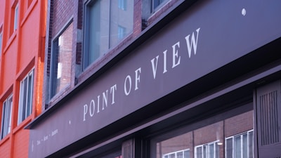 Point of view sign on a building facade.