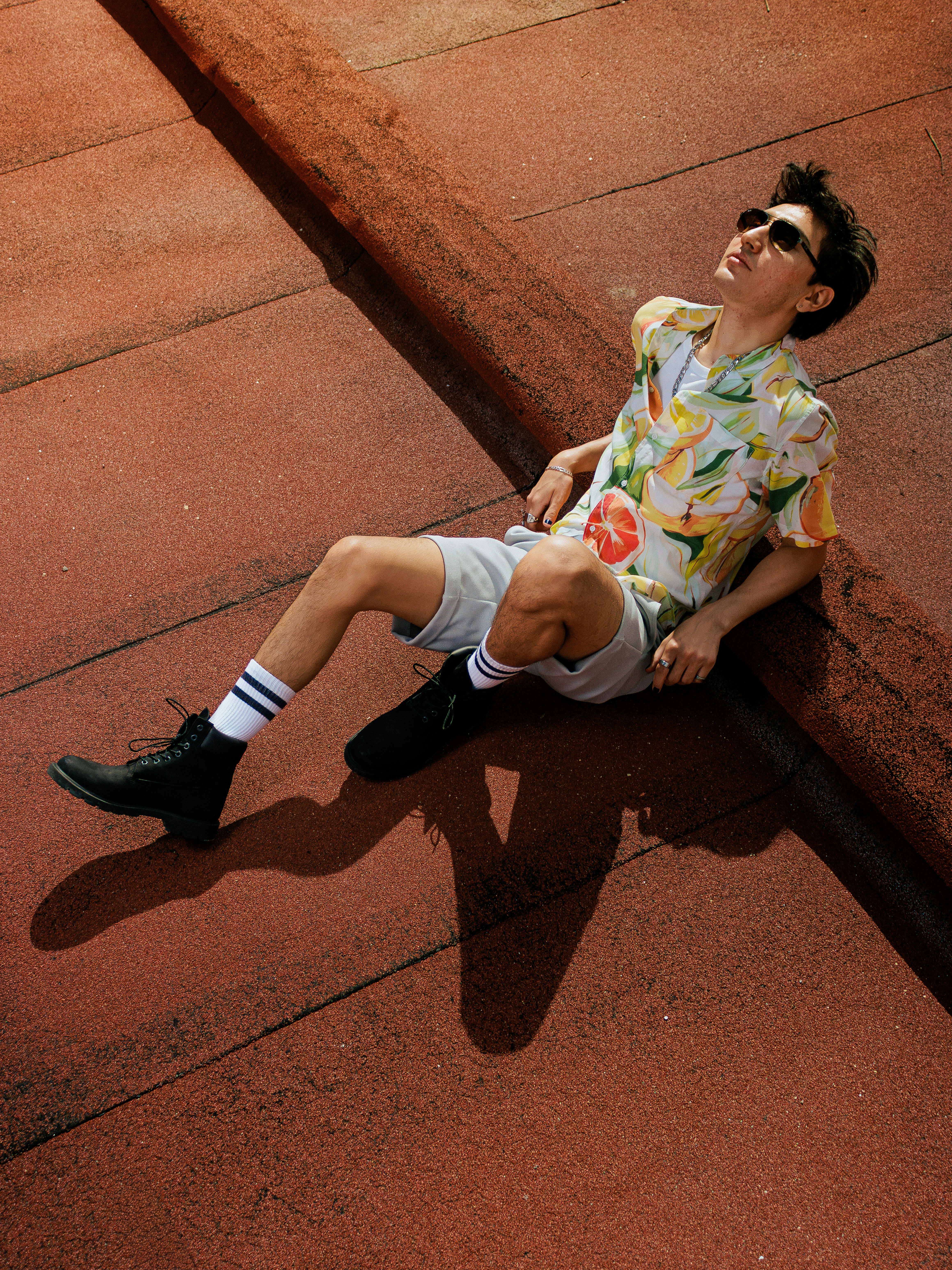 Young man in sunglasses relaxing on rooftop