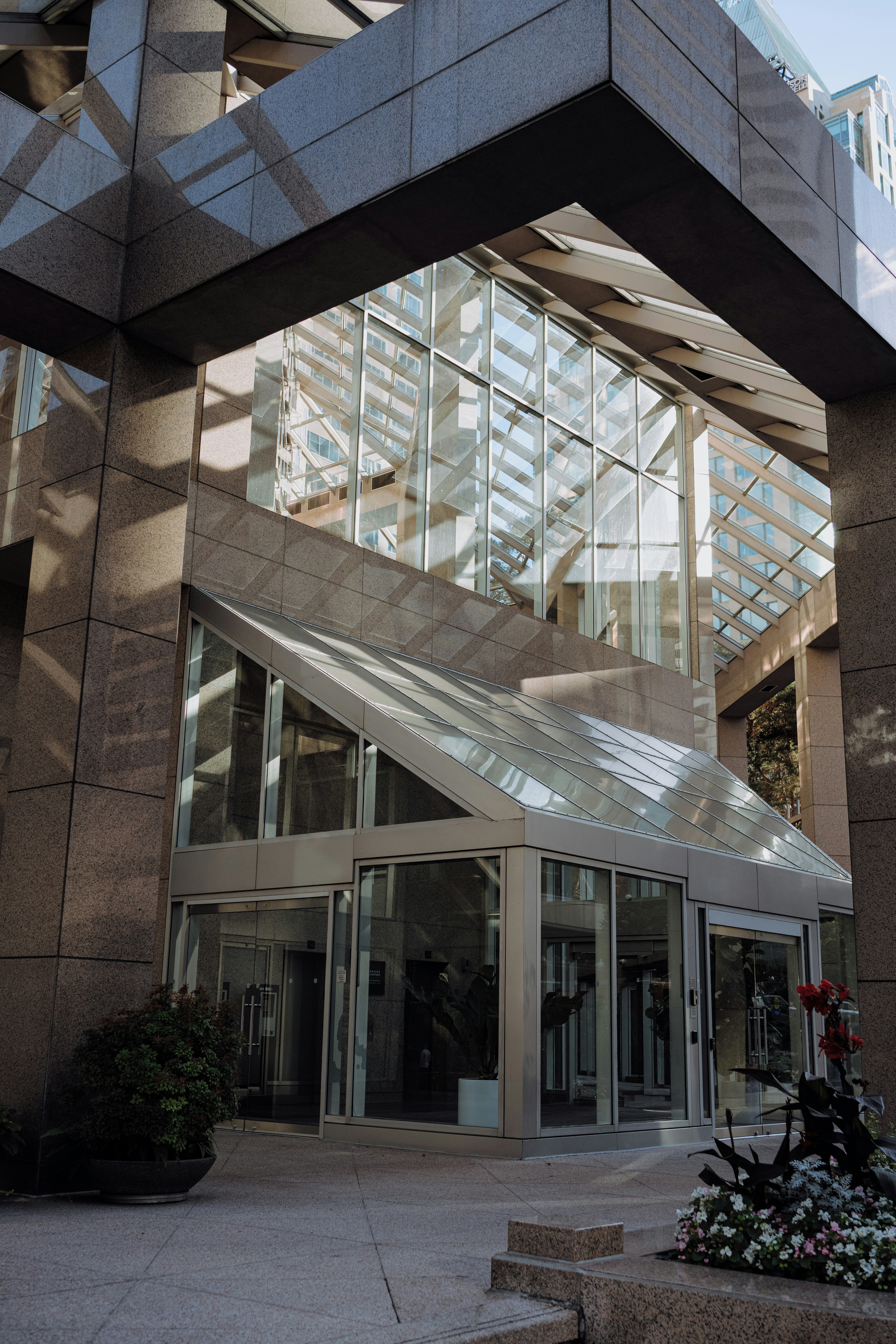 Modern glass building entrance with geometric design